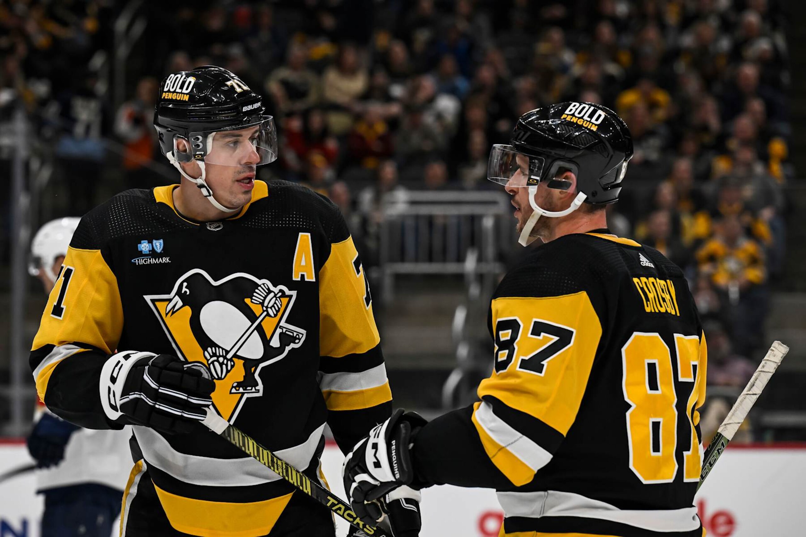 PITTSBURGH, PA - JANUARY 26: Pittsburgh Penguins center Evgeni Malkin (71) and Pittsburgh Penguins center Sidney Crosby (87) talk during the second period in the NHL game between the Pittsburgh Penguins and the Florida Panthers on January 26, 2024, at PPG Paints Arena in Pittsburgh, PA. (Photo by Jeanine Leech/Icon Sportswire via Getty Images)