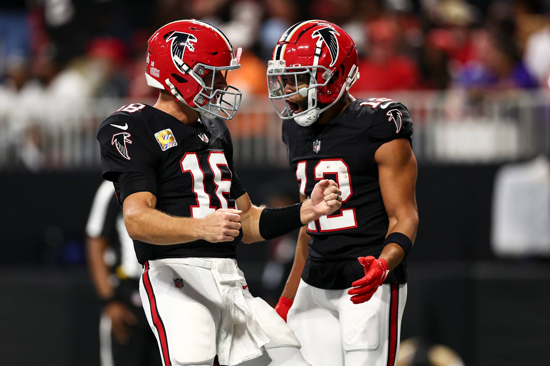 ATLANTA, GEORGIA - OCTOBER 3: Kirk Cousins #18 of the Atlanta Falcons celebrates with KhaDarel Hodge #12 after scoring a touchdown during the second quarter of an NFL football game against the Tampa Bay Buccaneers at Mercedes-Benz Stadium on October 3, 2024 in Atlanta, Georgia. (Photo by Kevin Sabitus/Getty Images)