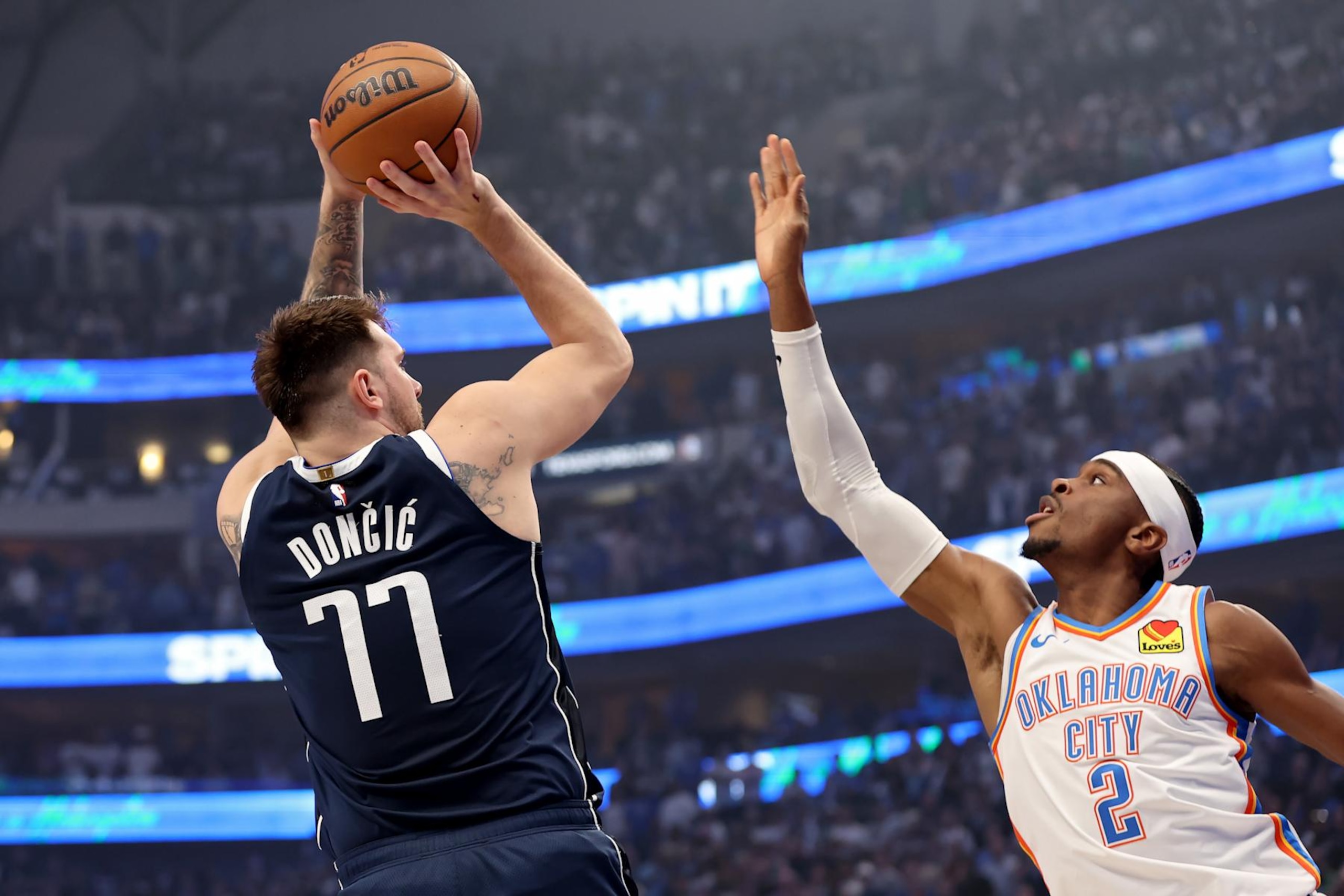 DALLAS, TEXAS - MAY 13: Luka Doncic #77 of the Dallas Mavericks shoots over Shai Gilgeous-Alexander #2 of the Oklahoma City Thunder during the first quarter in Game Four of the Western Conference Second Round Playoffs at American Airlines Center on May 13, 2024 in Dallas, Texas. NOTE TO USER: User expressly acknowledges and agrees that, by downloading and or using this photograph, User is consenting to the terms and conditions of the Getty Images License Agreement. (Photo by Tim Heitman/Getty Images) DALLAS, TEXAS - MAY 13: Luka Doncic #77 of the Dallas Mavericks shoots over Shai Gilgeous-Alexander #2 of the Oklahoma City Thunder during the first quarter in Game Four of the Western Conference Second Round Playoffs at American Airlines Center on May 13, 2024 in Dallas, Texas. NOTE TO USER: User expressly acknowledges and agrees that, by downloading and or using this photograph, User is consenting to the terms and conditions of the Getty Images License Agreement. (Photo by Tim Heitman/Getty Images)