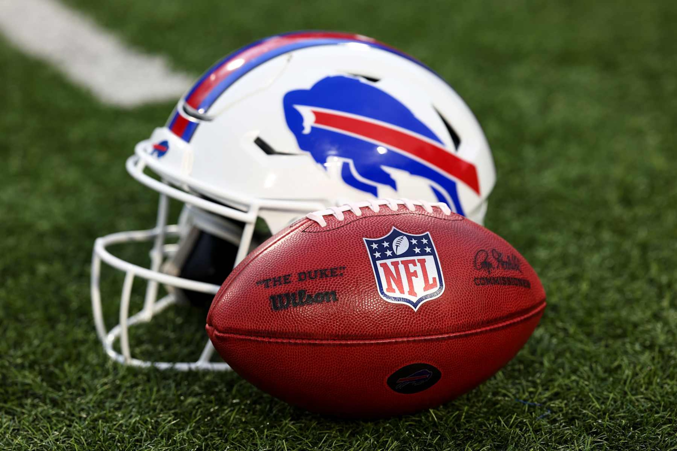 ORCHARD PARK, NY - SEPTEMBER 23: A detail shot of an official Wilson NFL football on the field next to a Buffalo Bills helmet prior to an NFL football game against the Jacksonville Jaguars at Highmark Stadium on September 23, 2024 in Orchard Park, New York. (Photo by Kevin Sabitus/Getty Images)
