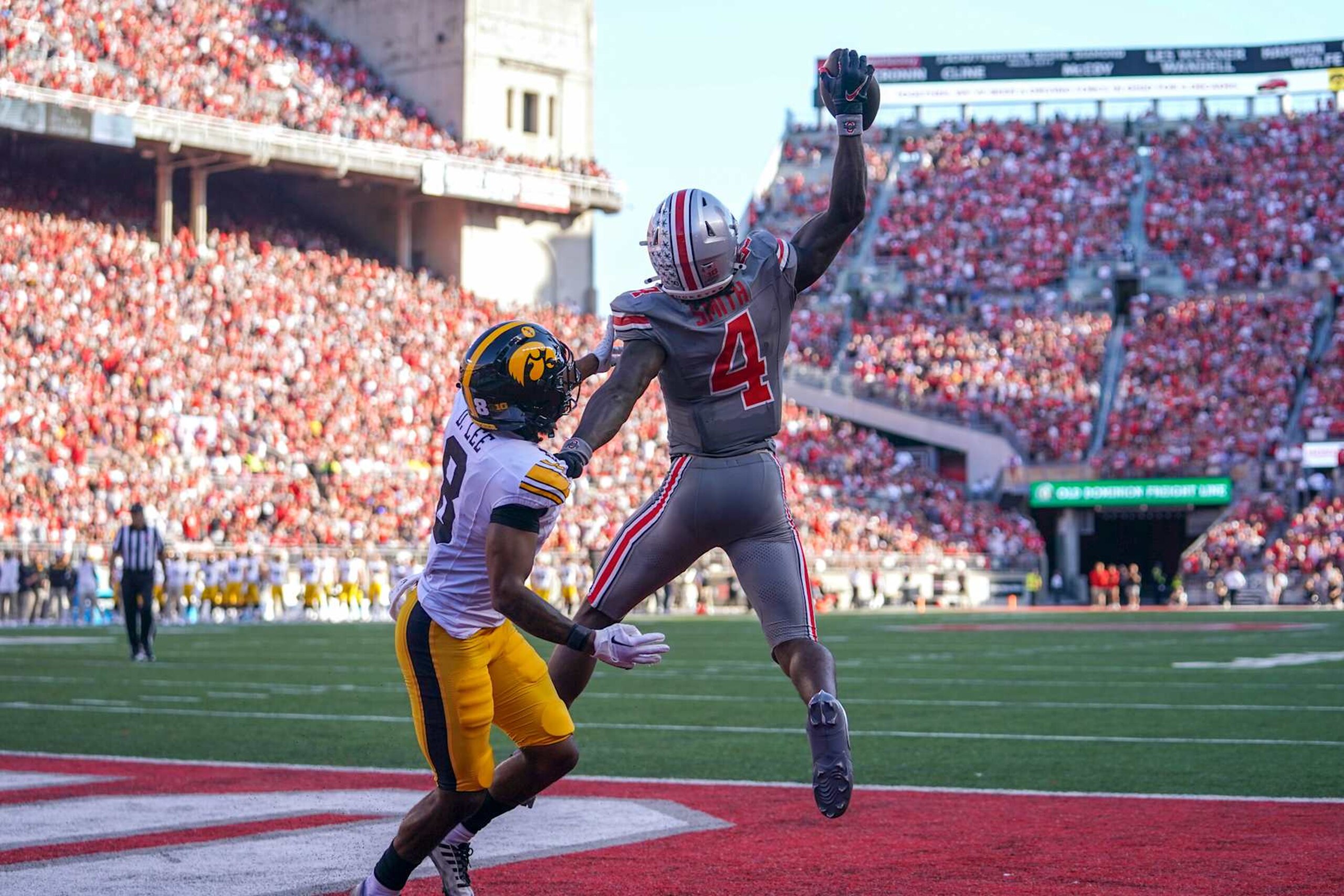 COLUMBUS, OHIO - OCTOBER 05: Wide receiver Jeremiah Smith #4 of the Ohio State Buckeyes catches a pass for a touchdown in the third quarter against the Iowa Hawkeyes at Ohio Stadium on October 05, 2024 in Columbus, Ohio. (Photo by Jason Mowry/Getty Images)