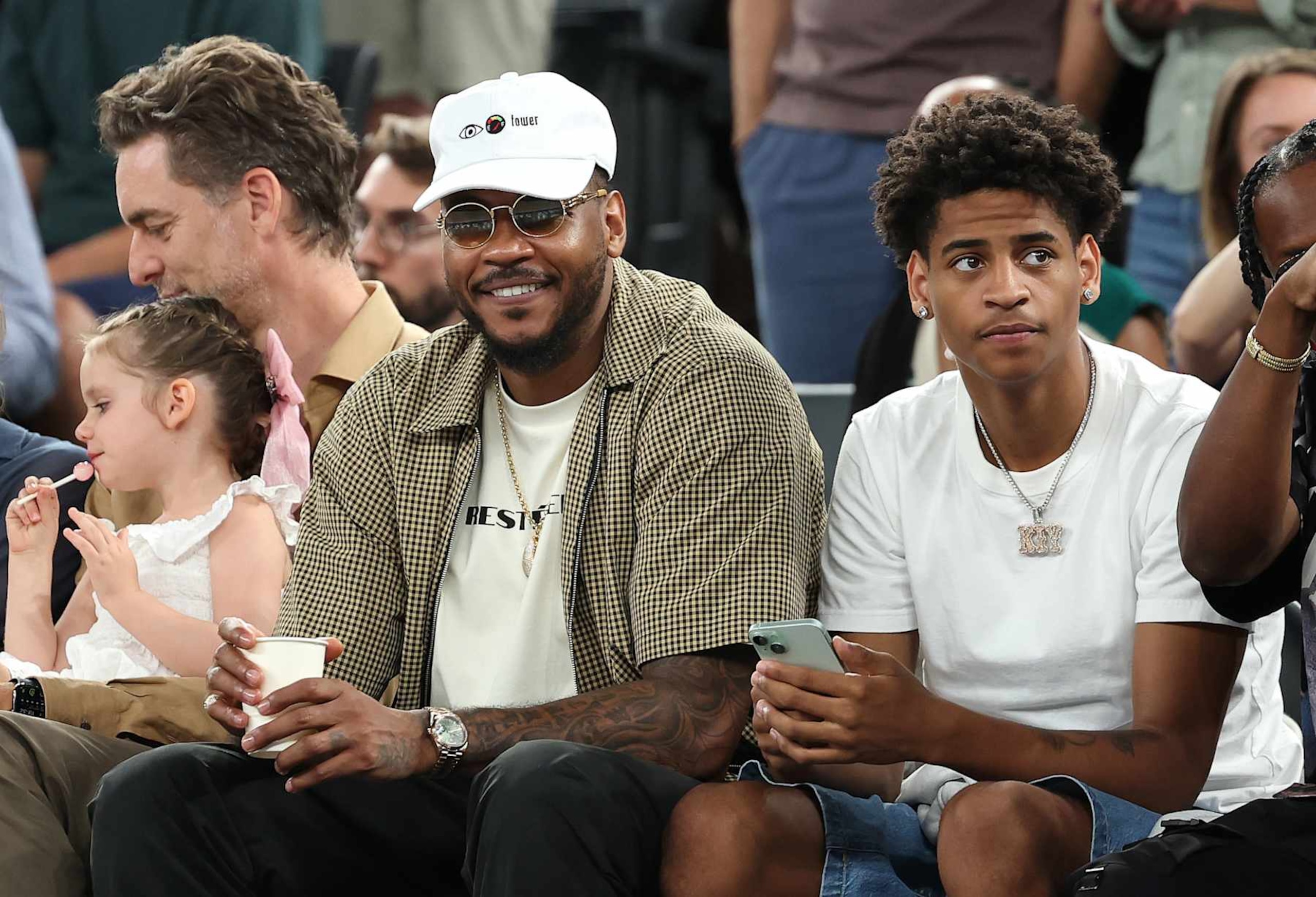 PARIS, FRANCE - AUGUST 06: Former NBA player Carmelo Anthony and Kiyan Anthony watch a Men's basketball quarterfinal game between Team Canada and Team France on day eleven of the Olympic Games Paris 2024 at Bercy Arena on August 06, 2024 in Paris, France. (Photo by Jamie Squire/Getty Images) PARIS, FRANCE - AUGUST 06: Former NBA player Carmelo Anthony and Kiyan Anthony watch a Men's basketball quarterfinal game between Team Canada and Team France on day eleven of the Olympic Games Paris 2024 at Bercy Arena on August 06, 2024 in Paris, France. (Photo by Jamie Squire/Getty Images)