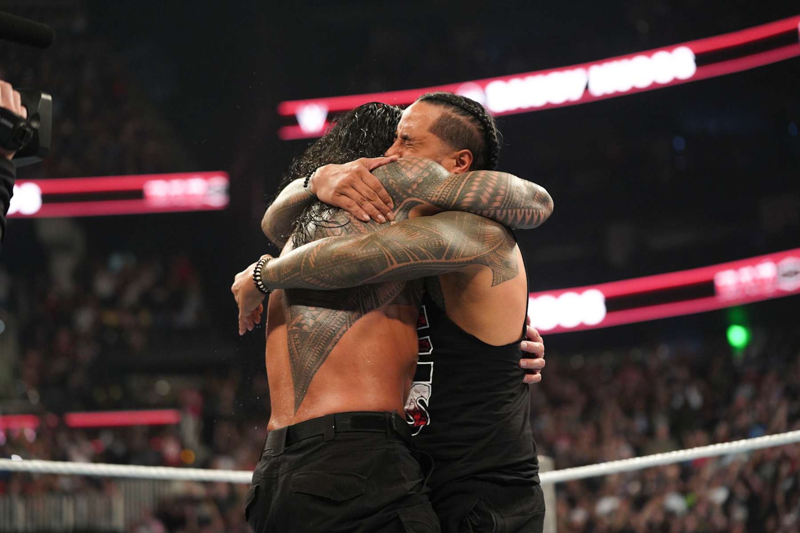 ATLANTA, GEORGIA - OCTOBER 5: Roman Reigns and Jimmy Uso embrace during Bad Blood at State Farm Arena on October 5, 2024 in Atlanta, Georgia.  (Photo by WWE/Getty Images)