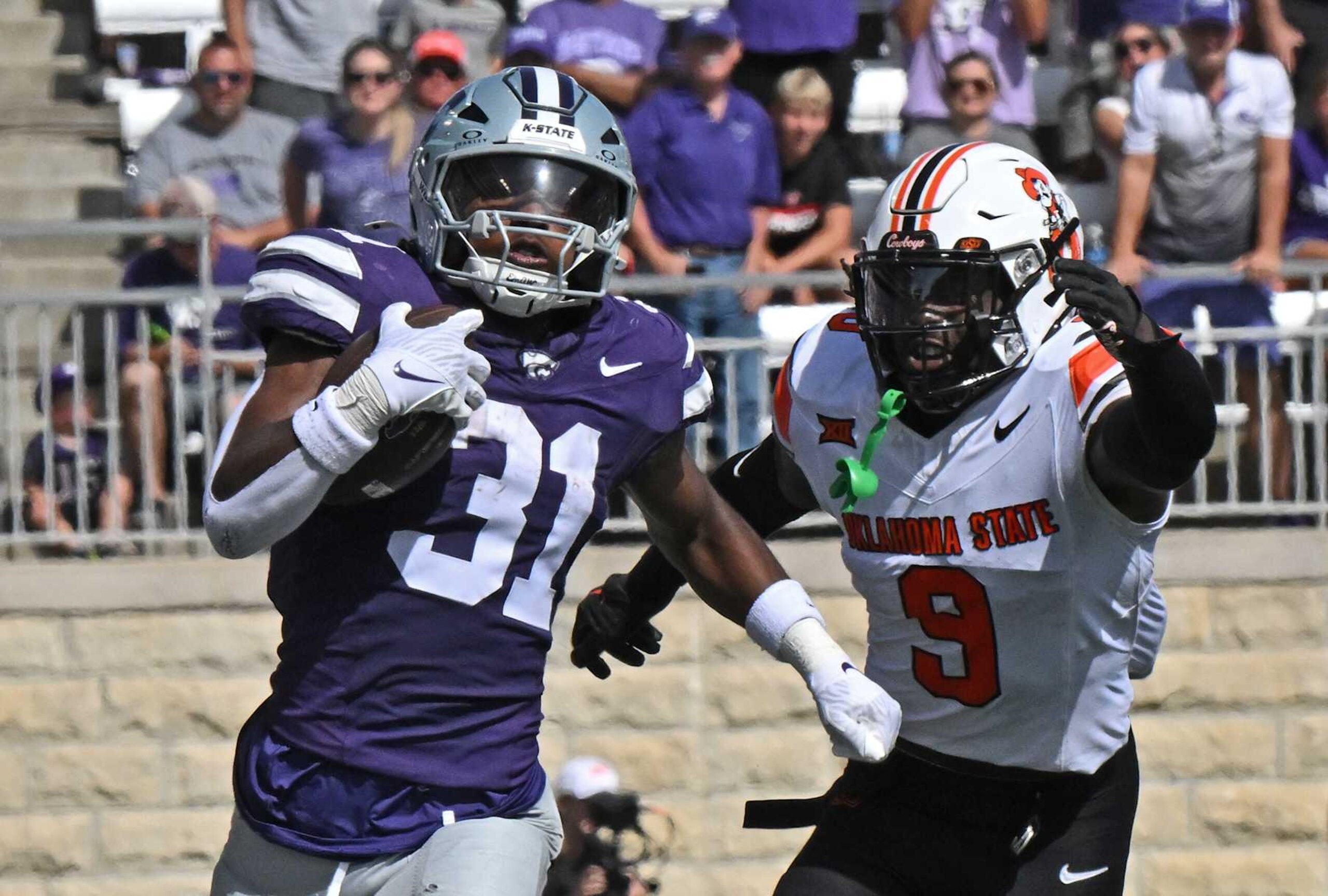MANHATTAN, KS - SEPTEMBER 28:  Running back DJ Giddens #31 of the Kansas State Wildcats runs up field for a first down past safety Trey Rucker #9 of the Oklahoma State Cowboys in the first half at Bill Snyder Family Football Stadium on September 28, 2024 in Manhattan, Kansas. (Photo by Peter Aiken/Getty Images)