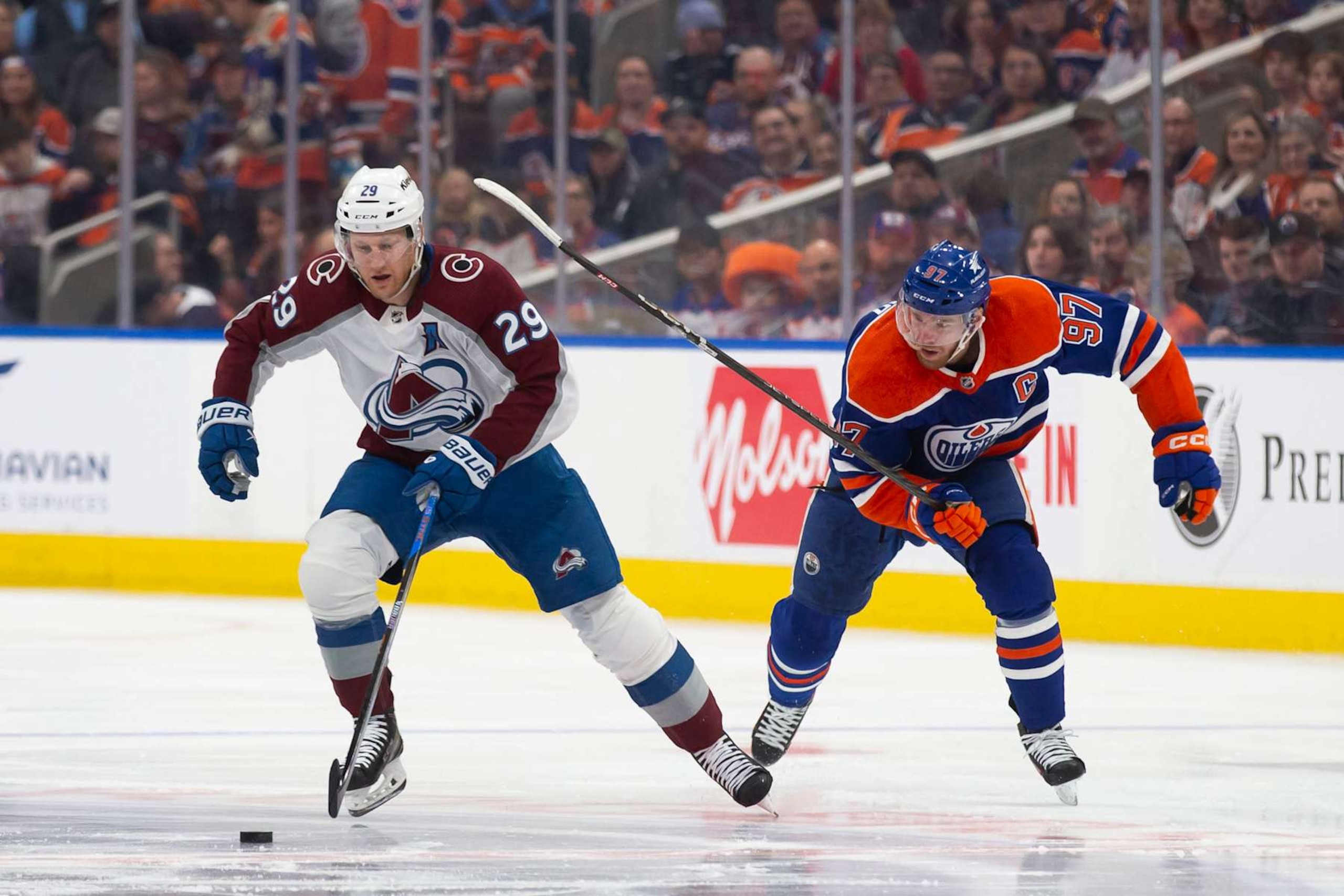 EDMONTON, CANADA - APRIL 5: Connor McDavid #97 of the Edmonton Oilers skates against Nathan MacKinnon #29 of the Colorado Avalanche during the first period at Rogers Place on April 5, 2024 in Edmonton, Canada. (Photo by Codie McLachlan/Getty Images)