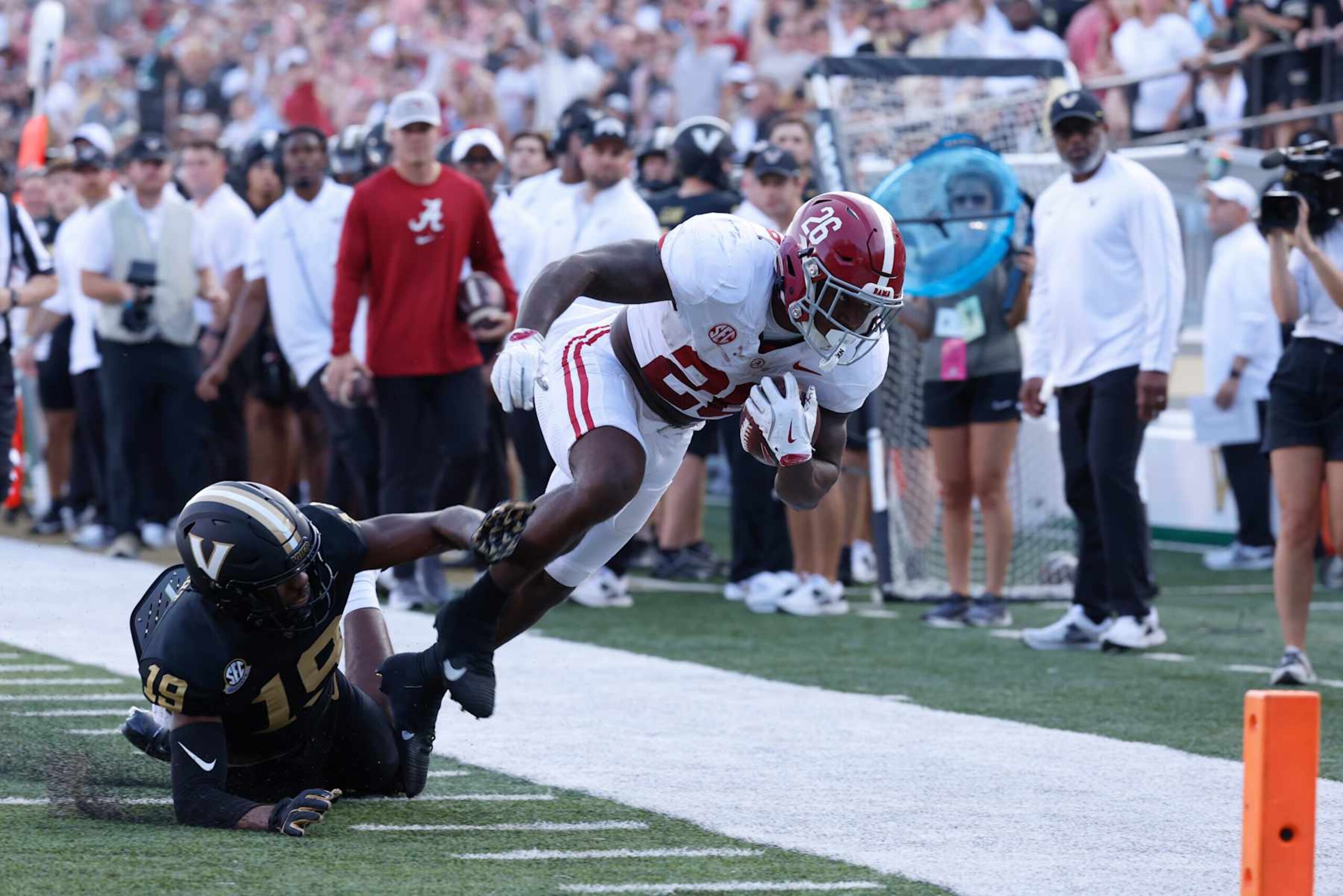 NASHVILLE, TN - OCTOBER 05: Alabama Crimson Tide running back Jam Miller (26) is knocked out of bounds by Vanderbilt Commodores safety De'Rickey Wright (19) during a game between the Vanderbilt Commodores and Alabama Crimson Tide, October 5, 2024 at FirstBank Stadium in Nashville, Tennessee. (Photo by Matthew Maxey/Icon Sportswire via Getty Images)