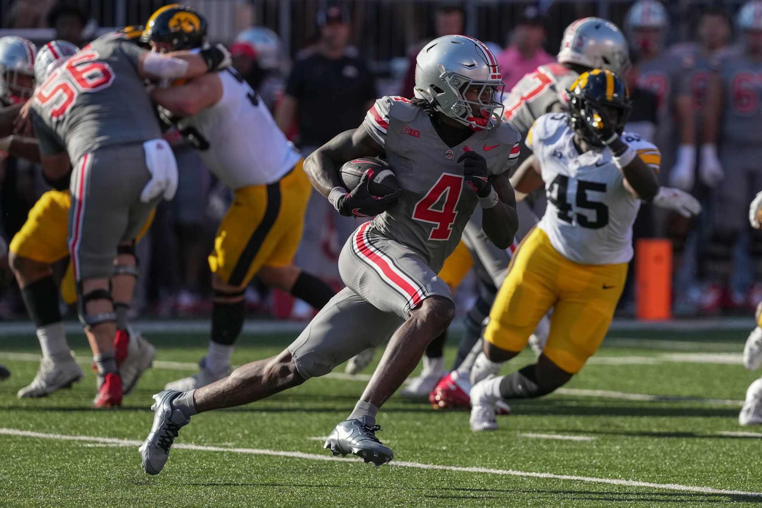COLUMBUS, OHIO - OCTOBER 05: Wide receiver Jeremiah Smith #4 of the Ohio State Buckeyes carries the ball against the Iowa Hawkeyes during the second quarter at Ohio Stadium on October 05, 2024 in Columbus, Ohio. (Photo by Jason Mowry/Getty Images)