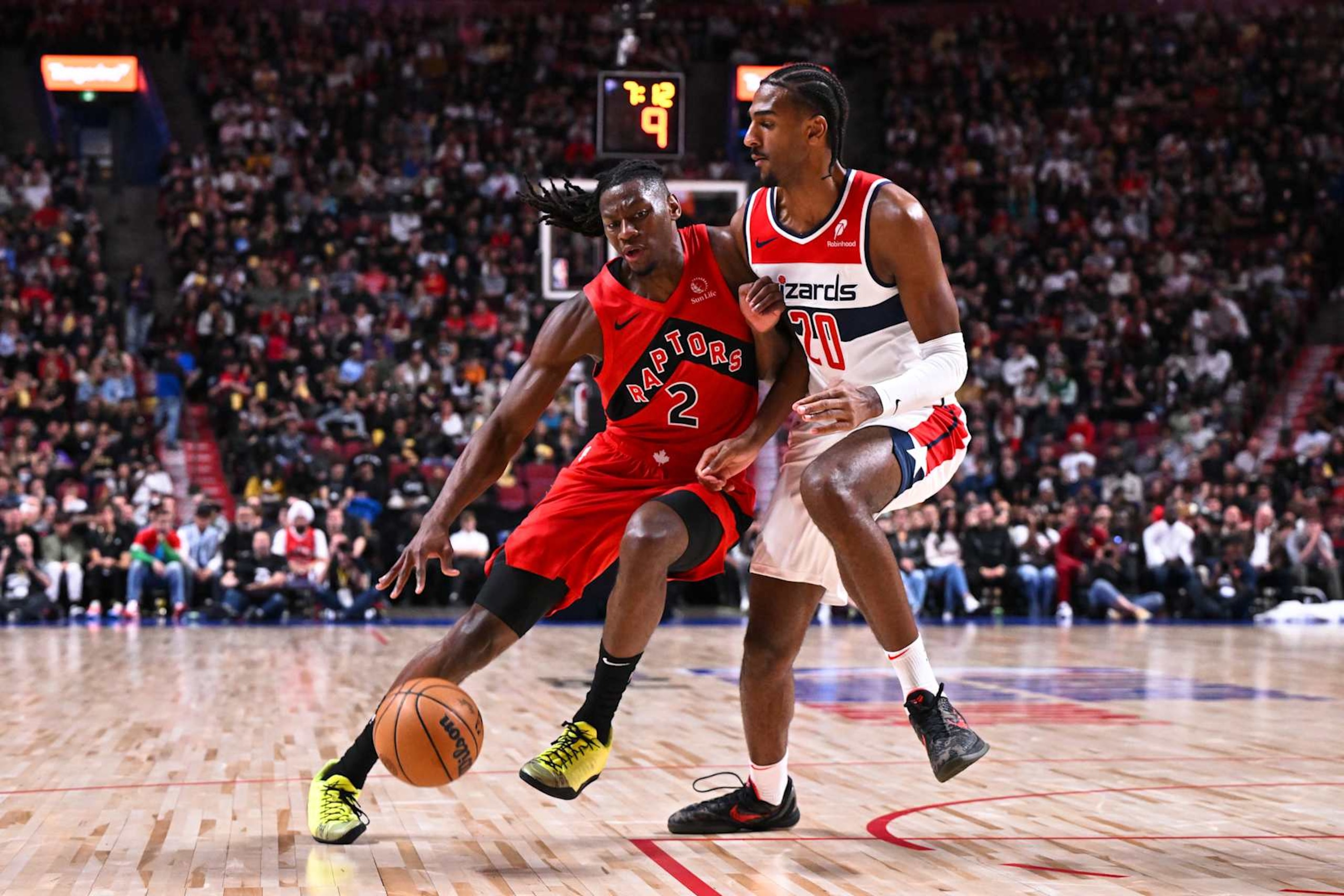 MONTREAL, CANADA - OCTOBER 06: Jonathan Mogbo #2 of the Toronto Raptors dribbles the ball against Alex Sarr #20 of the Washington Wizards during the first half of a preseason NBA game at the Bell Centre on October 6, 2024 in Montreal, Quebec, Canada. NOTE TO USER: User expressly acknowledges and agrees that, by downloading and or using this photograph, User is consenting to the terms and conditions of the Getty Images License Agreement. (Photo by Minas Panagiotakis/Getty Images) MONTREAL, CANADA - OCTOBER 06: Jonathan Mogbo #2 of the Toronto Raptors dribbles the ball against Alex Sarr #20 of the Washington Wizards during the first half of a preseason NBA game at the Bell Centre on October 6, 2024 in Montreal, Quebec, Canada. NOTE TO USER: User expressly acknowledges and agrees that, by downloading and or using this photograph, User is consenting to the terms and conditions of the Getty Images License Agreement. (Photo by Minas Panagiotakis/Getty Images)