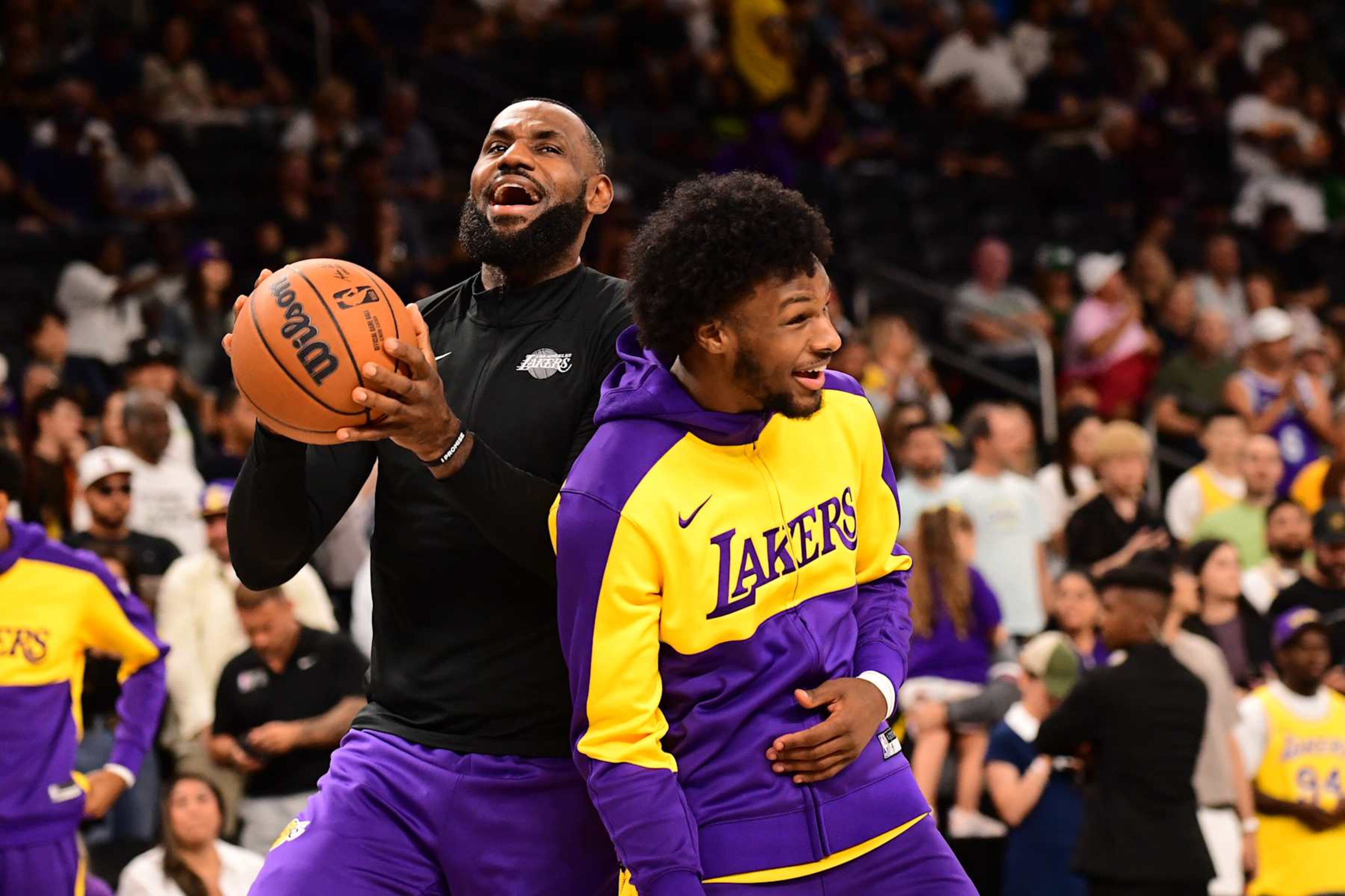 LOS ANGELES, CA - OCTOBER 6: LeBron James #23 and Bronny James #9 of the Los Angeles Lakers smile before the game against the Phoenix Suns on October 6, 2024 at Acrisure Arena in Palm Springs, California. NOTE TO USER: User expressly acknowledges and agrees that, by downloading and/or using this Photograph, user is consenting to the terms and conditions of the Getty Images License Agreement. Mandatory Copyright Notice: Copyright 2024 NBAE (Photo by Adam Pantozzi/NBAE via Getty Images) LOS ANGELES, CA - OCTOBER 6: LeBron James #23 and Bronny James #9 of the Los Angeles Lakers smile before the game against the Phoenix Suns on October 6, 2024 at Acrisure Arena in Palm Springs, California. NOTE TO USER: User expressly acknowledges and agrees that, by downloading and/or using this Photograph, user is consenting to the terms and conditions of the Getty Images License Agreement. Mandatory Copyright Notice: Copyright 2024 NBAE (Photo by Adam Pantozzi/NBAE via Getty Images)