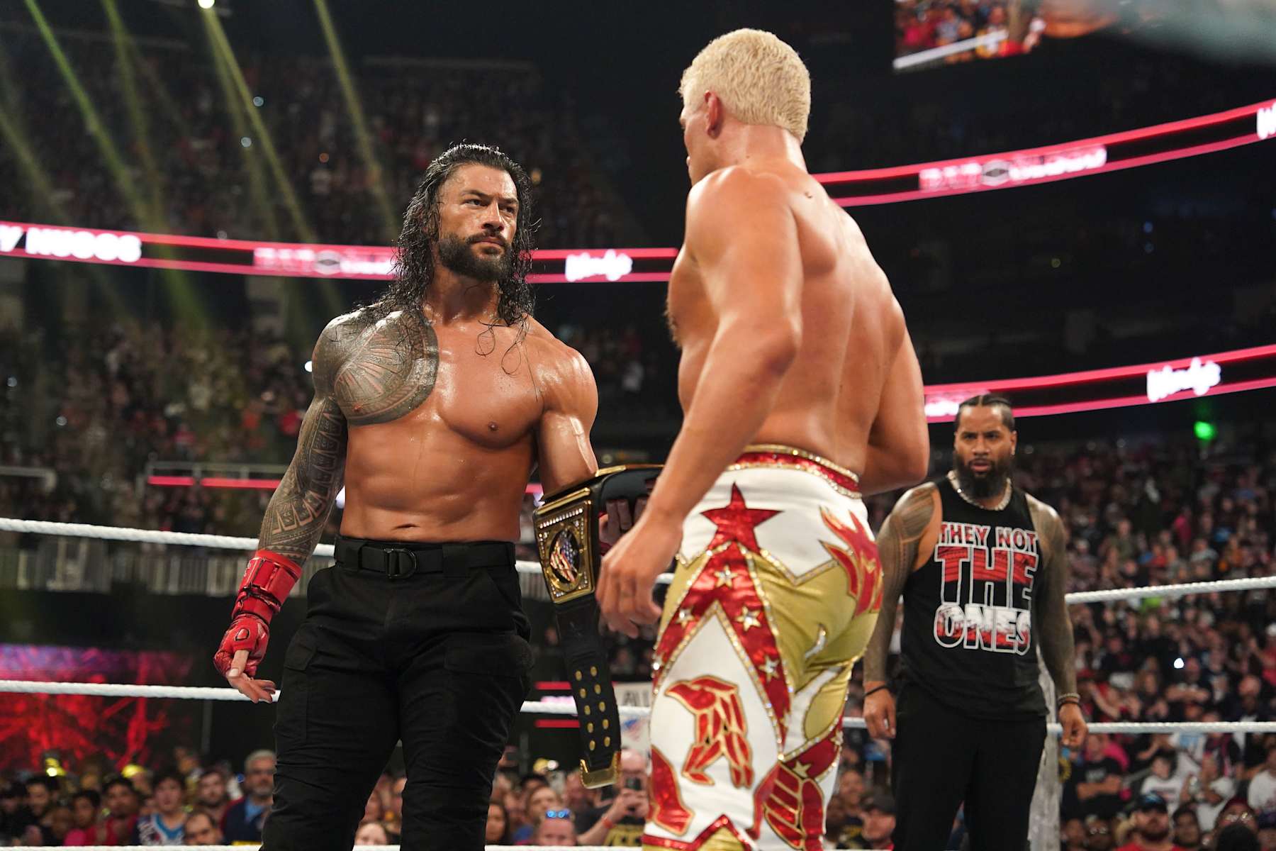 ATLANTA, GEORGIA - OCTOBER 5: Roman Reigns gives Cody Rhodes his title during Bad Blood at State Farm Arena on October 5, 2024 in Atlanta, Georgia.  (Photo by WWE/Getty Images)