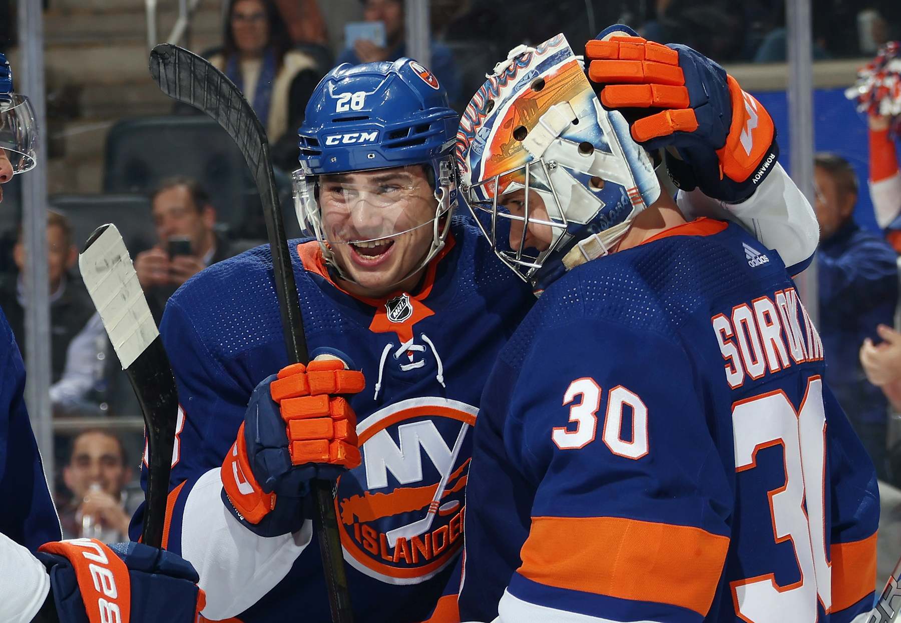 ELMONT, NEW YORK - APRIL 02: Alexander Romanov #28 and Ilya Sorokin #30 of the New York Islanders celebrate their 2-1 victory over the Chicago Blackhawks at UBS Arena on April 02, 2024 in Elmont, New York. (Photo by Bruce Bennett/Getty Images)