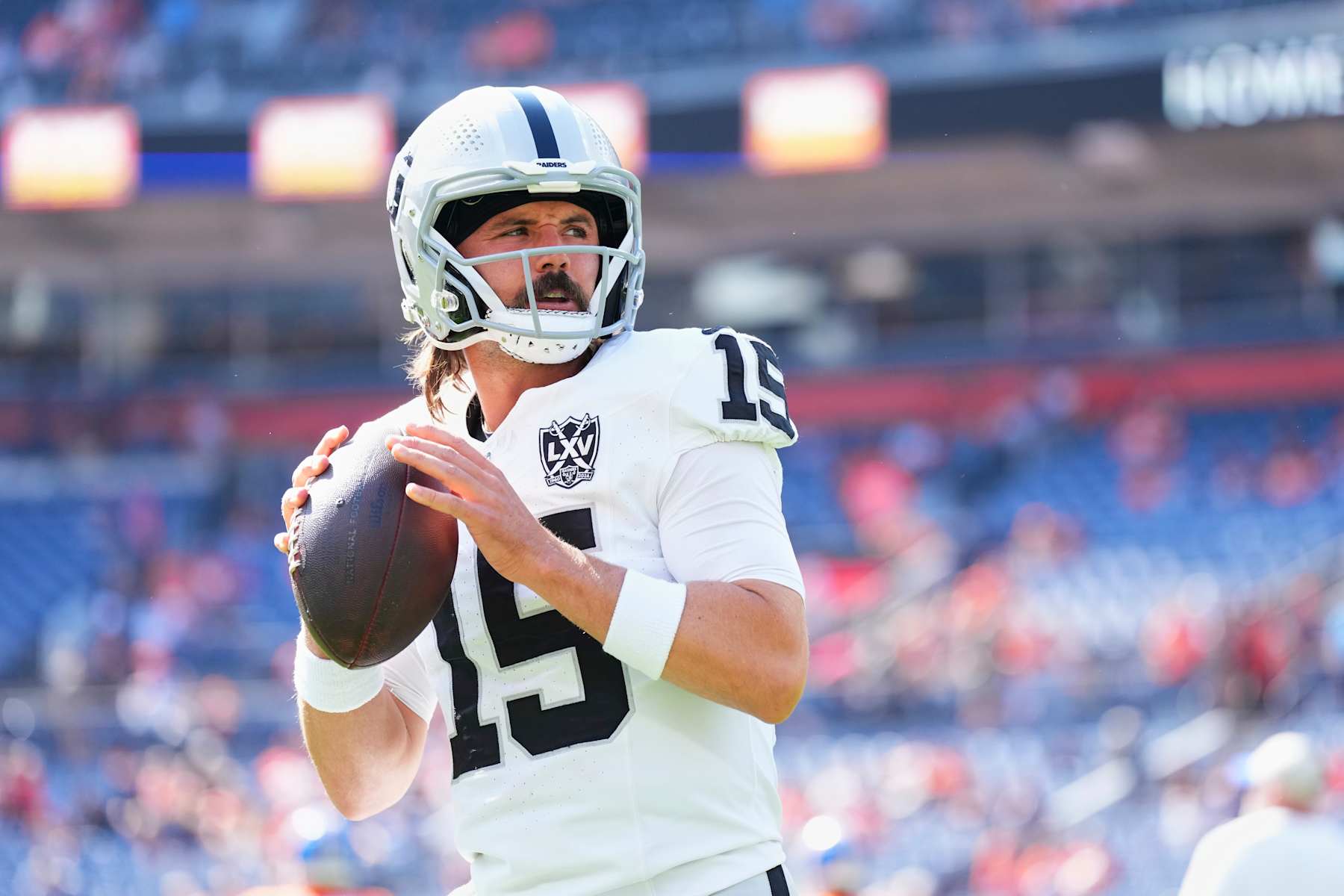 DENVER, CO - OCTOBER 06: Gardner Minshew #15 of the Las Vegas Raiders warms up before kickoff against the Denver Broncos during an NFL football game at Empower Field at Mile High on October 6, 2024 in Denver, Colorado. (Photo by Cooper Neill/Getty Images)