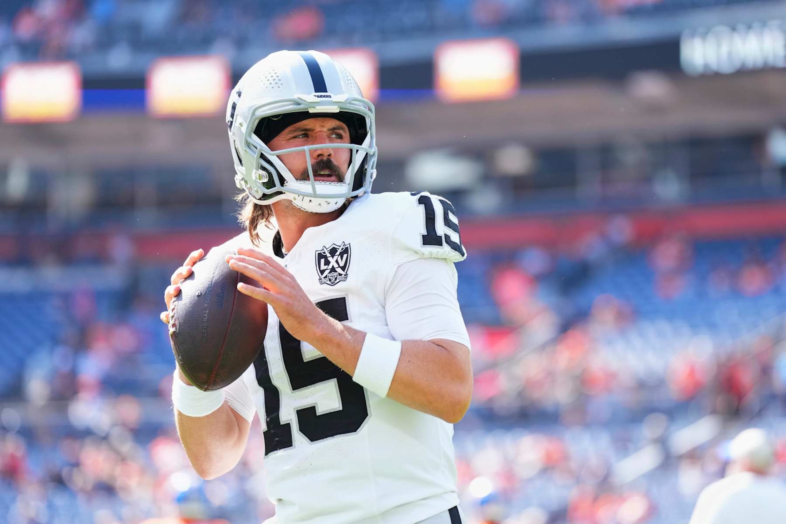 DENVER, CO - OCTOBER 06: Gardner Minshew #15 of the Las Vegas Raiders warms up before kickoff against the Denver Broncos during an NFL football game at Empower Field at Mile High on October 6, 2024 in Denver, Colorado. (Photo by Cooper Neill/Getty Images)
