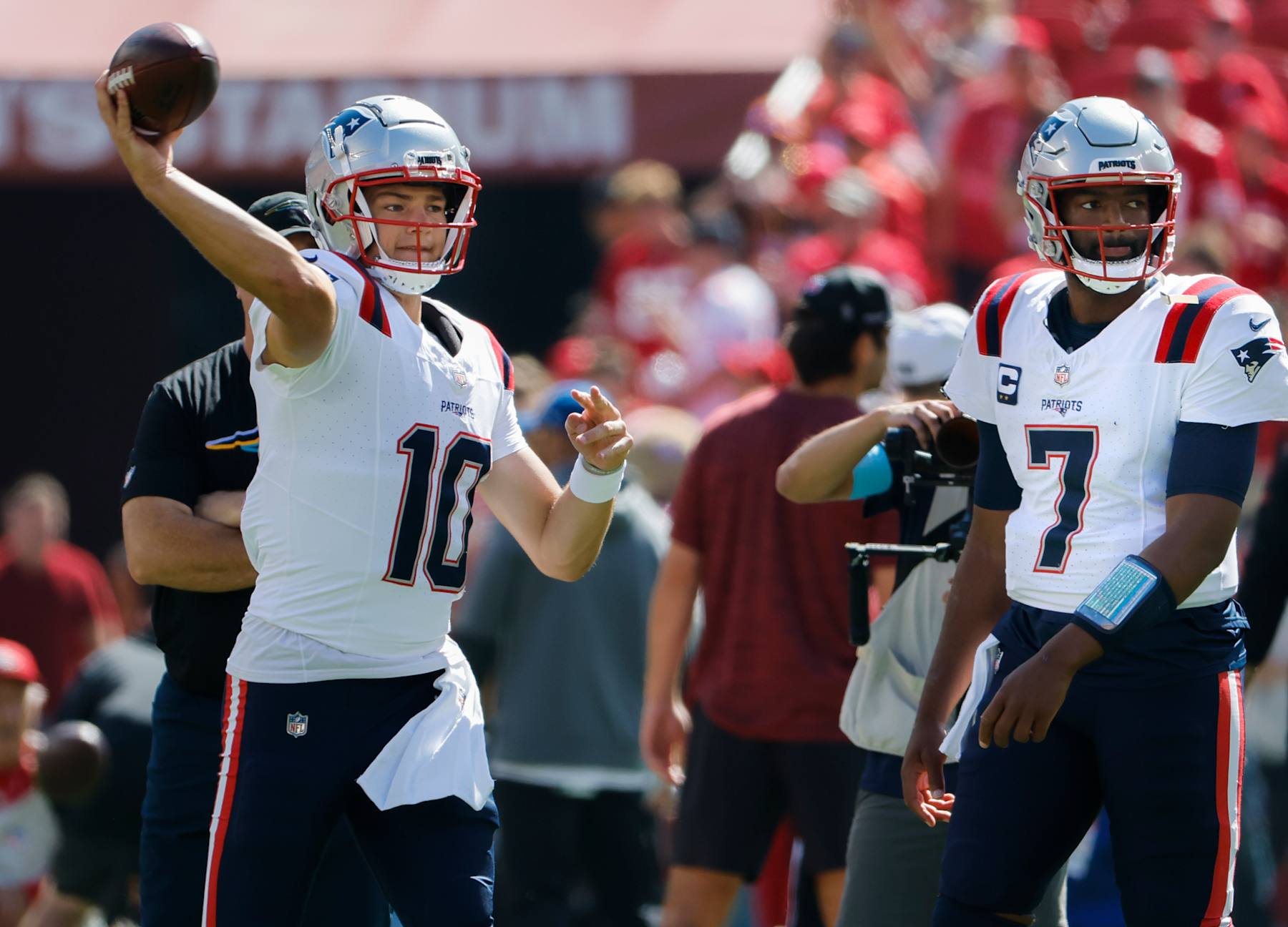 Santa Clara, CA - September 29: New England Patriots QB Drake Maye throws a warmup pass before the game as Jacoby Brissett looks on. (Photo by Matthew J. Lee/The Boston Globe via Getty Images)