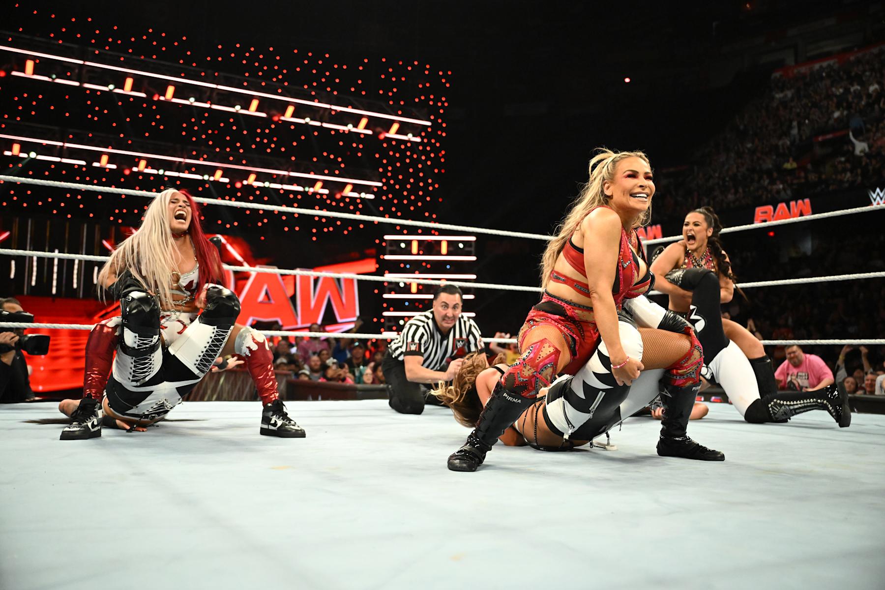 CALGARY, CANADA - SEPTEMBER 09: (L-R) Zelina Vega, Natalya and Lyra Valkyria but submission holds against members of The Pure Fusion Collective during Monday Night RAW at the Scotiabank Saddledome on September 9, 2024 in Calgary, Canada.  (Photo by WWE/Getty Images)