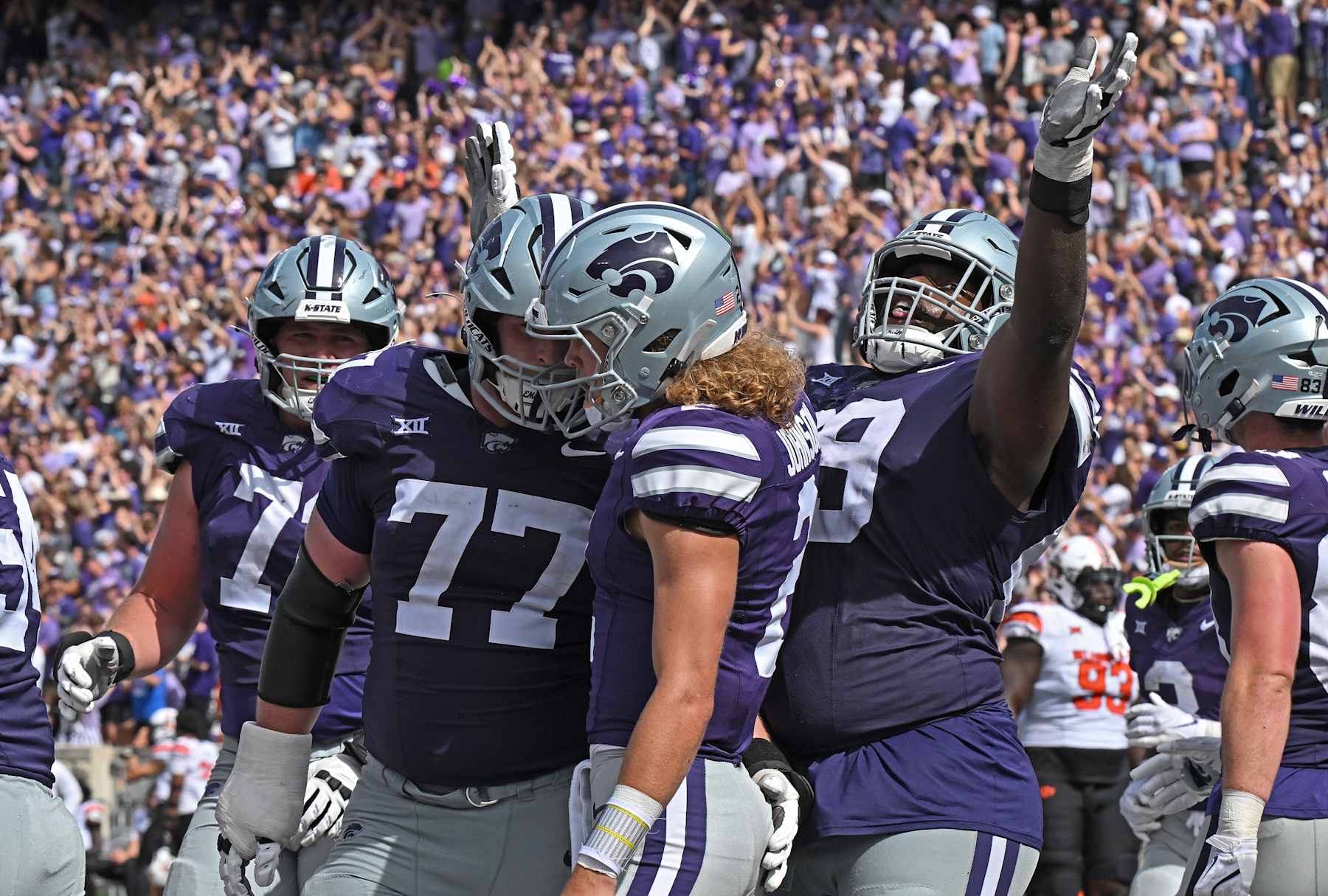 MANHATTAN, KS - SEPTEMBER 28:  Quarterback Avery Johnson #2 of the Kansas State Wildcats celebrates after scoring a touchdown with teammates Carver Willis #77 and Taylor Poitier #69, against the Oklahoma State Cowboys in the second half at Bill Snyder Family Football Stadium on September 28, 2024 in Manhattan, Kansas. (Photo by Peter Aiken/Getty Images)
