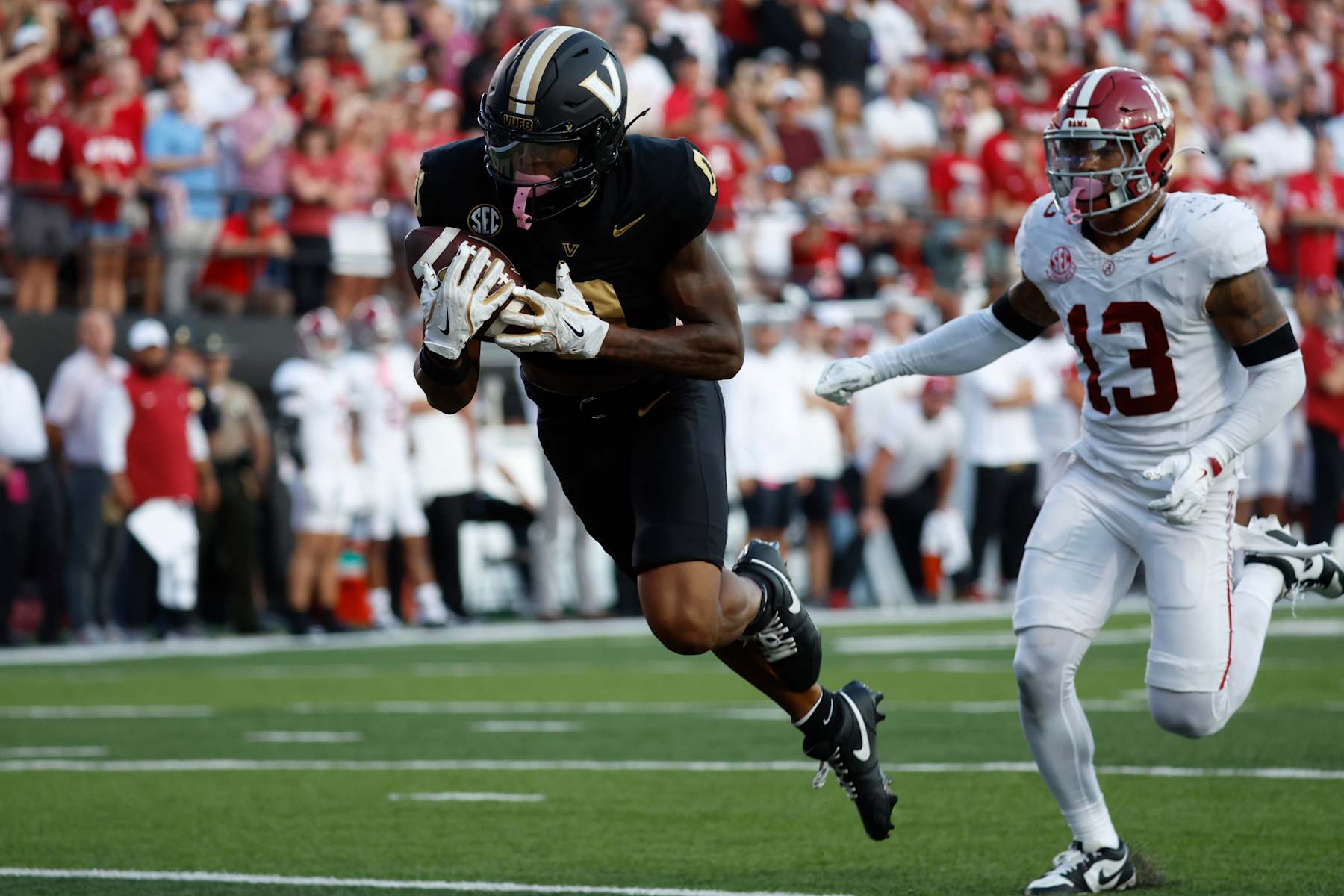 NASHVILLE, TN - OCTOBER 05: Vanderbilt Commodores wide receiver Junior Sherrill (0) runs in for a touchdown in front of Alabama Crimson Tide defensive back Malachi Moore (13) during a game between the Vanderbilt Commodores and Alabama Crimson Tide, October 5, 2024 at FirstBank Stadium in Nashville, Tennessee. (Photo by Matthew Maxey/Icon Sportswire via Getty Images)