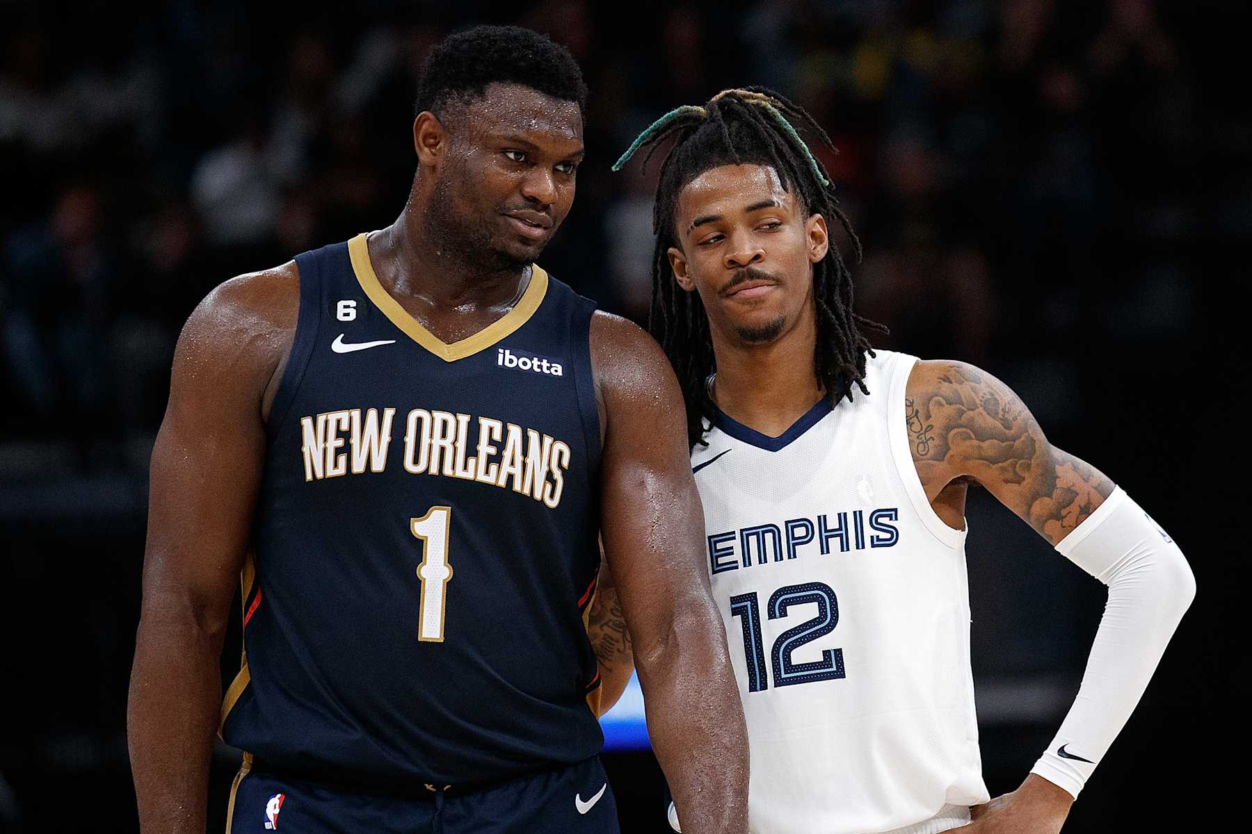 MEMPHIS, TENNESSEE - DECEMBER 31: Zion Williamson #1 of the New Orleans Pelicans and Ja Morant #12 of the Memphis Grizzlies during the second half at FedExForum on December 31, 2022 in Memphis, Tennessee. NOTE TO USER: User expressly acknowledges and agrees that, by downloading and or using this photograph, User is consenting to the terms and conditions of the Getty Images License Agreement. (Photo by Justin Ford/Getty Images)