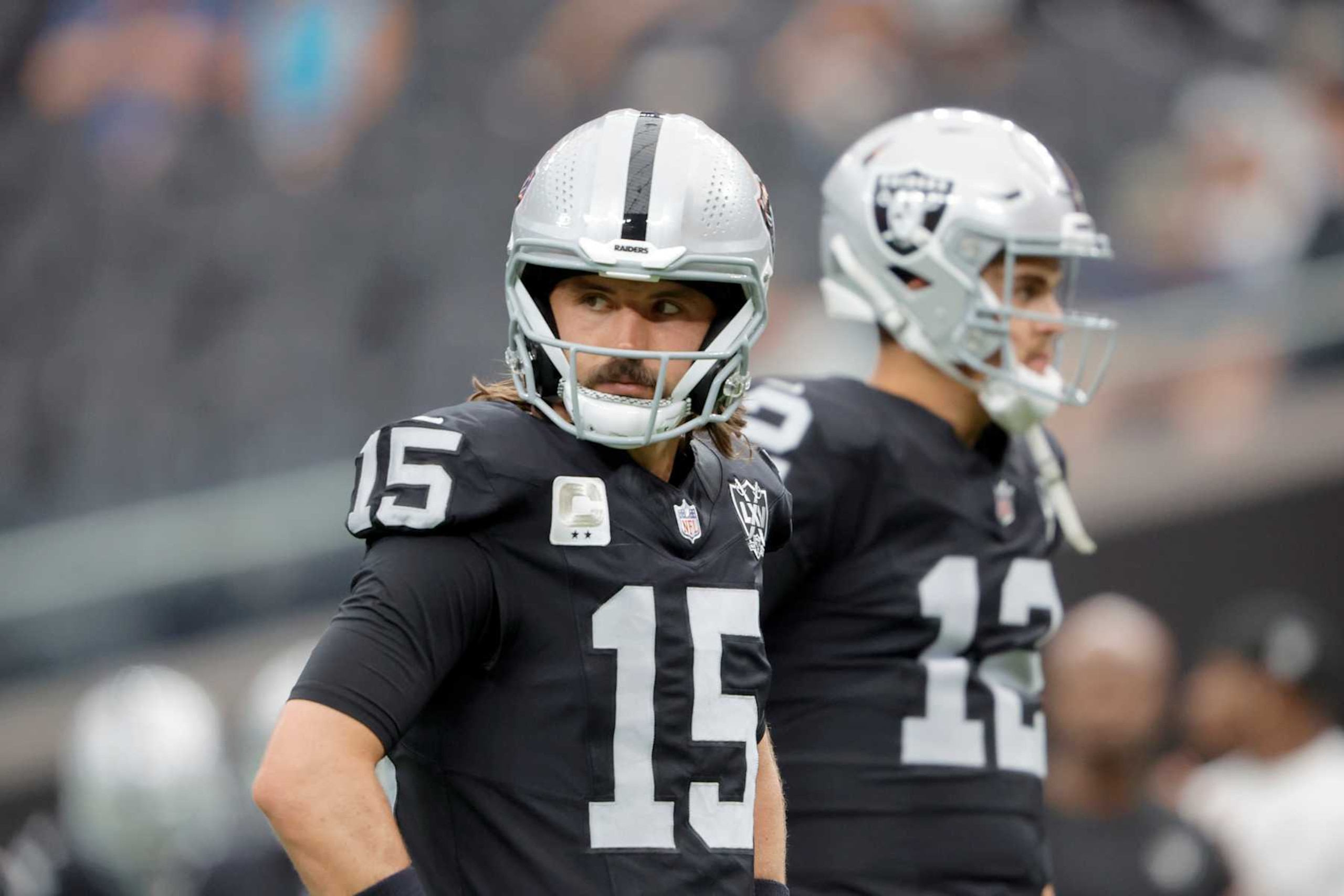 LAS VEGAS, NEVADA - SEPTEMBER 22: Gardner Minshew II #15 and Aidan O'Connell #12 of the Las Vegas Raiders warm up before a game against the Carolina Panthers at Allegiant Stadium on September 22, 2024 in Las Vegas, Nevada. (Photo by Steve Marcus/Getty Images)