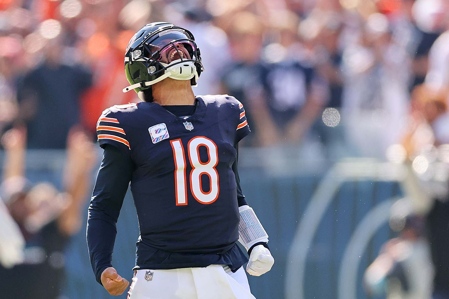 CHICAGO, ILLINOIS - OCTOBER 06: Caleb Williams #18 of the Chicago Bears reacts after throwing a touchdown pass to DJ Moore #2 (not pictured) against the Carolina Panthers during the second quarter  at Soldier Field on October 06, 2024 in Chicago, Illinois. (Photo by Michael Reaves/Getty Images)