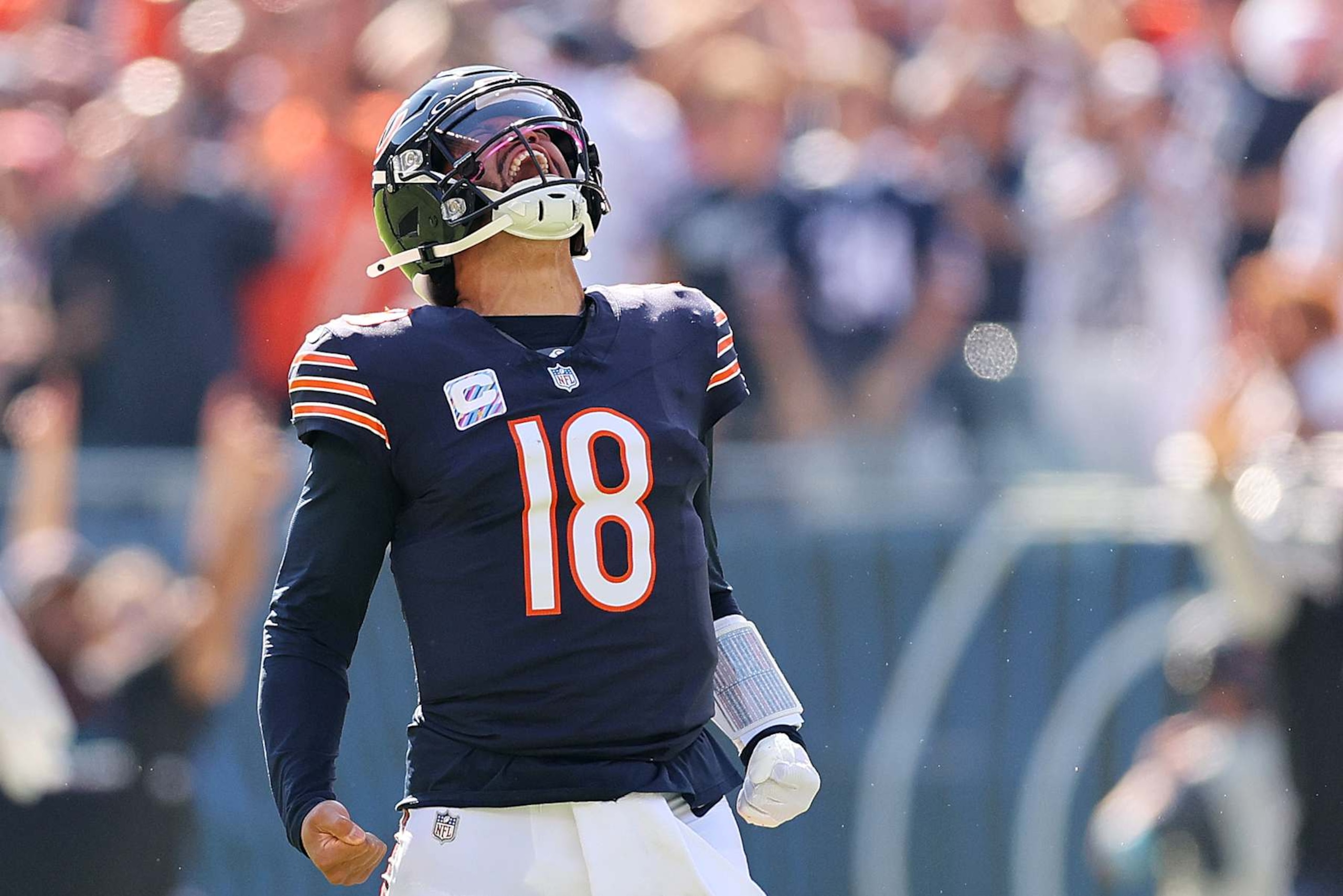CHICAGO, ILLINOIS - OCTOBER 06: Caleb Williams #18 of the Chicago Bears reacts after throwing a touchdown pass to DJ Moore #2 (not pictured) against the Carolina Panthers during the second quarter  at Soldier Field on October 06, 2024 in Chicago, Illinois. (Photo by Michael Reaves/Getty Images)