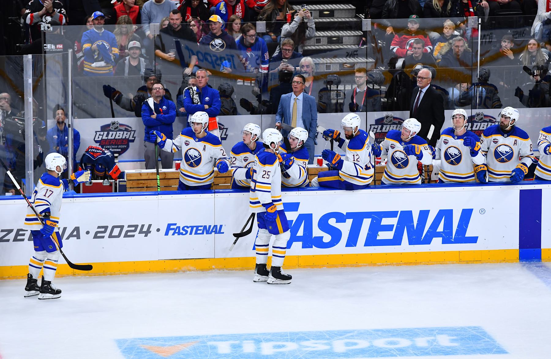 PRAGUE, CZECH REPUBLIC - OCTOBER 04: Jason Zucker #17 and Owen Power #25 of the Buffalo Sabres skate by the bench to celebrate Power's goal during the third period during the 2024 NHL Global Series-Czechia game between the New Jersey Devils and the Buffalo Sabres at O2 Arena on October 04, 2024 in Prague, Czech Republic. (Photo by Ben Jackson/NHLI via Getty Images)