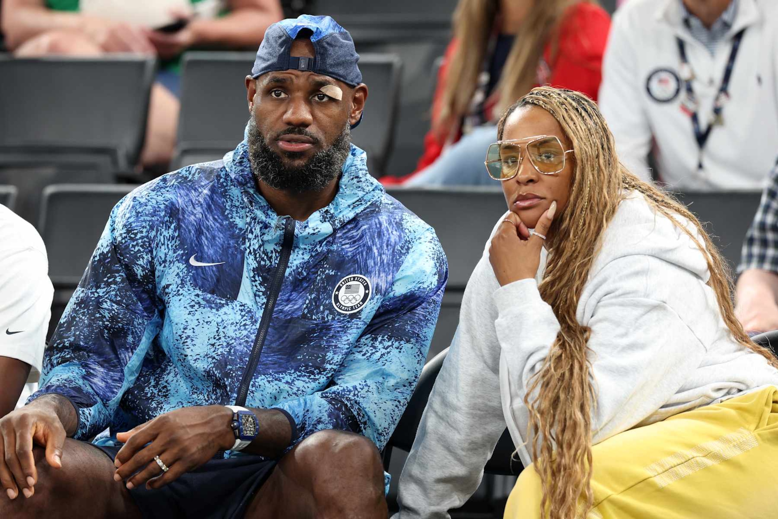 PARIS, FRANCE - AUGUST 07: LeBron James of Team United States and wife, Savannah James, look on during a Women's basketball quarterfinal game between Team United States and Team Nigeria on day twelve of the Olympic Games Paris 2024 at Bercy Arena on August 07, 2024 in Paris, France. (Photo by Pascal Le Segretain/Getty Images)