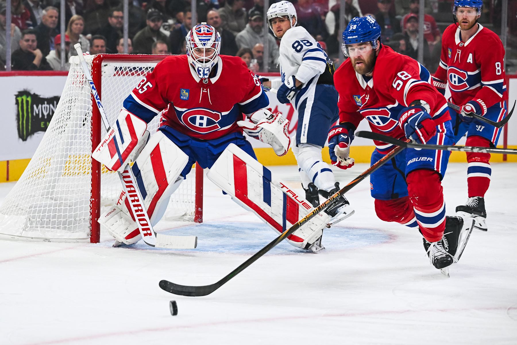 MONTREAL, QC - OCTOBER 09: Montreal Canadiens defenseman David Savard (58) gains control of the puck near Montreal Canadiens goalie Sam Montembeault (35) during the Toronto Maple Leafs versus the Montreal Canadiens game on October 09, 2024, at Bell Centre in Montreal, QC (Photo by David Kirouac/Icon Sportswire via Getty Images)