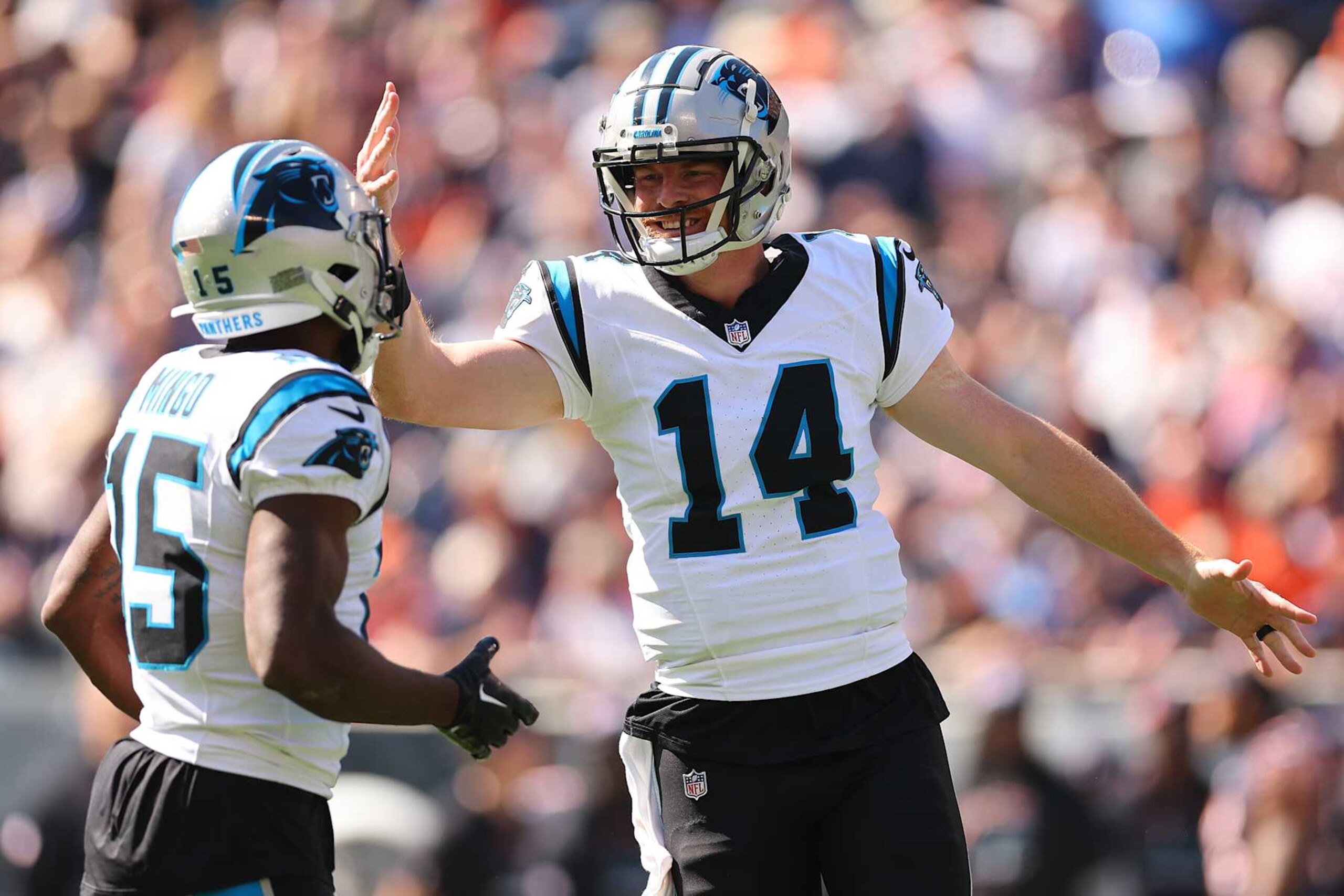 CHICAGO, ILLINOIS - OCTOBER 06: Andy Dalton #14 of the Carolina Panthers celebrates a touchdown with Jonathan Mingo #15 against the Chicago Bears during the first quarter at Soldier Field on October 06, 2024 in Chicago, Illinois. (Photo by Michael Reaves/Getty Images)