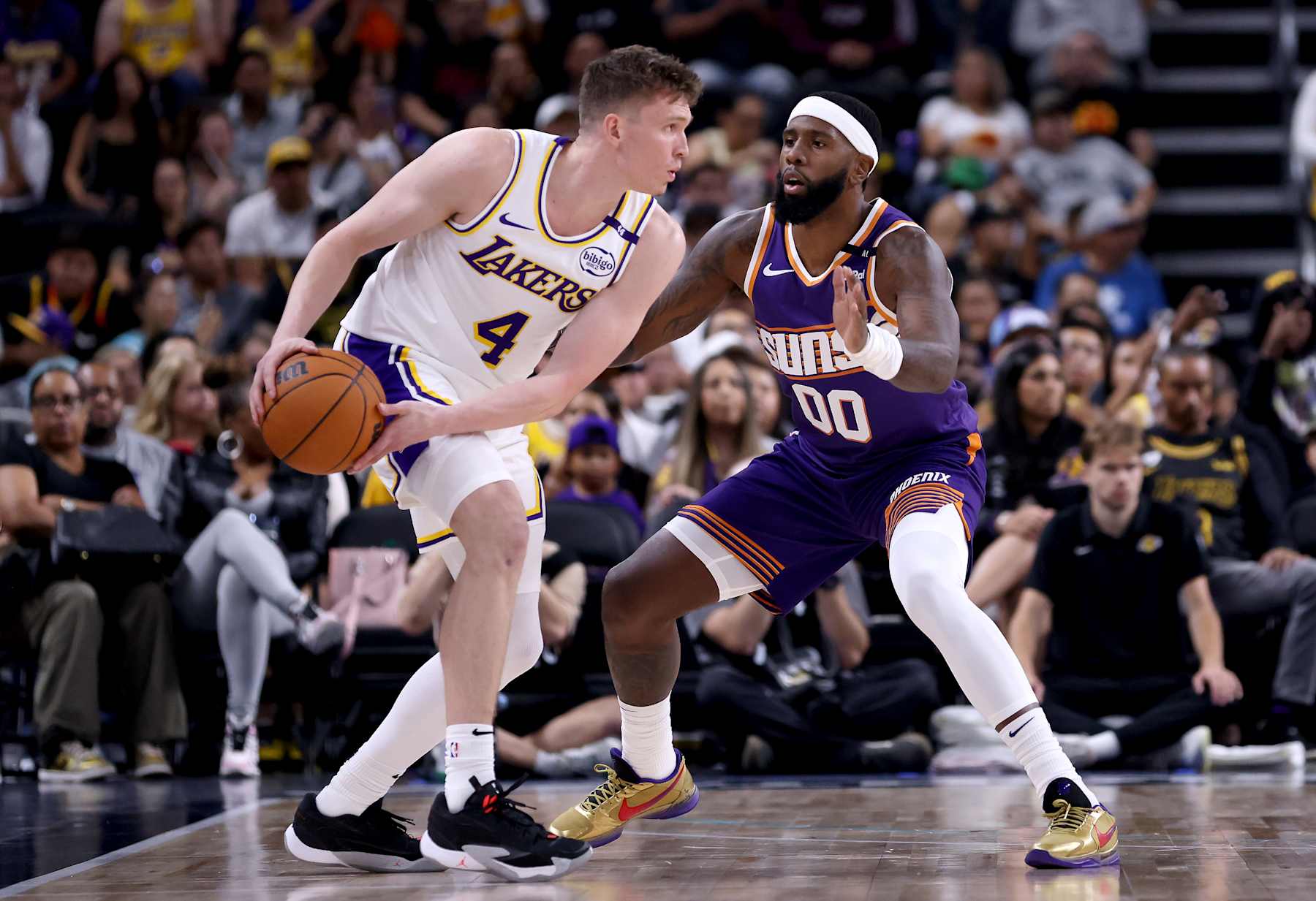 PALM SPRINGS, CALIFORNIA - OCTOBER 06: Dalton Knecht #4 of the Los Angeles Lakers looks for an opening against Royce O'Neale #00 of the Phoenix Suns during the second quarter at Acrisure Arena on October 06, 2024 in Palm Springs, California. NOTE TO USER: User expressly acknowledges and agrees that, by downloading and/or using this photograph, user is consenting to the terms and conditions of the Getty Images License Agreement. (Photo by Katelyn Mulcahy/Getty Images)