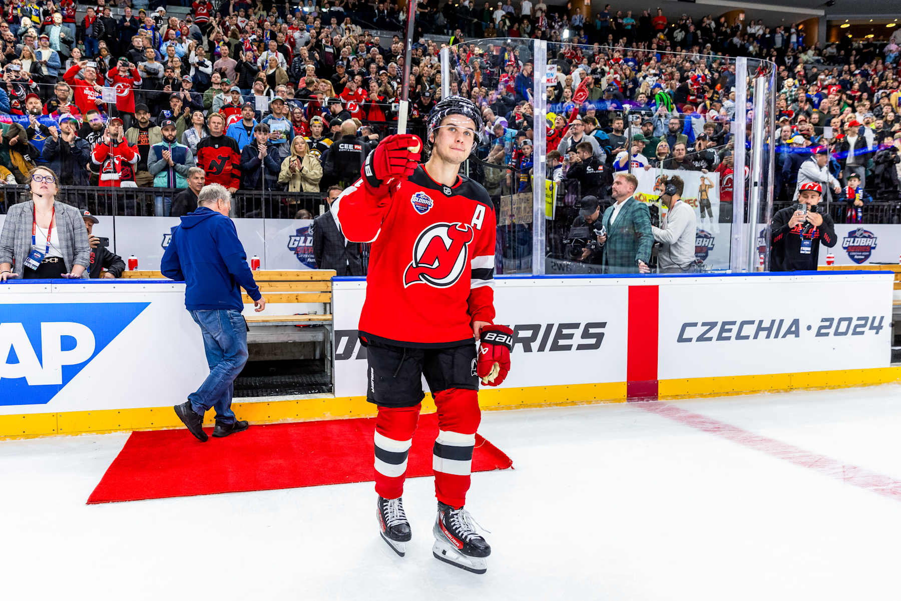 PRAGUE, CZECH REPUBLIC - OCTOBER 05: Jack Hughes #86 of the New Jersey Devils salutes the crowd after being named the second star of the game at the 2024 NHL Global Series Czechia between the New Jersey Devils and the Buffalo Sabres on October 05, 2024 in Prague, Czech Republic. (Photo by Andrew Maclean/NHLI via Getty Images)