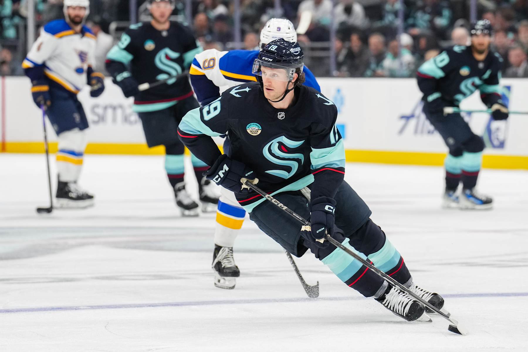 SEATTLE, WASHINGTON - OCTOBER 08: Jared McCann #19 of the Seattle Kraken skates with the puck during the second period of a game against the St. Louis Blues at Climate Pledge Arena on October 8, 2024 in Seattle, Washington. (Photo by Christopher Mast/NHLI via Getty Images)