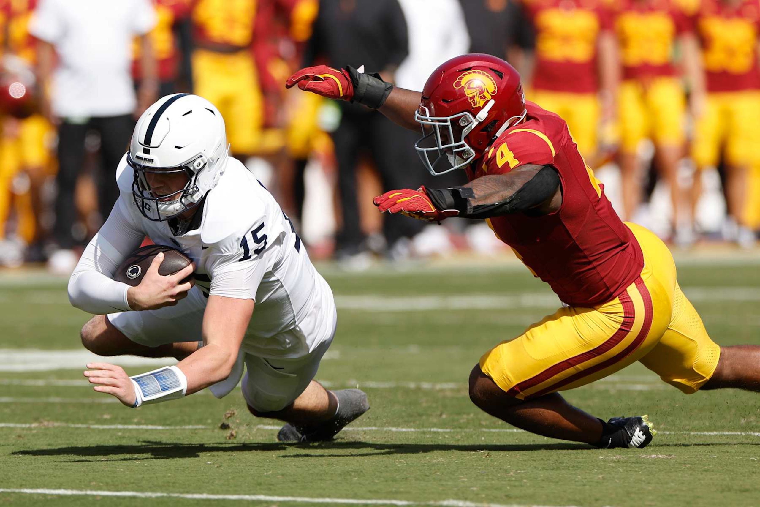 LOS ANGELES, CALIFORNIA - OCTOBER 12: Drew Allar #15 of the Penn State Nittany Lions runs the ball against Easton Mascarenas-Arnold #4 of the USC Trojans during the second quarter at United Airlines Field at the Los Angeles Memorial Coliseum on October 12, 2024 in Los Angeles, California. (Photo by Kevork Djansezian/Getty Images)