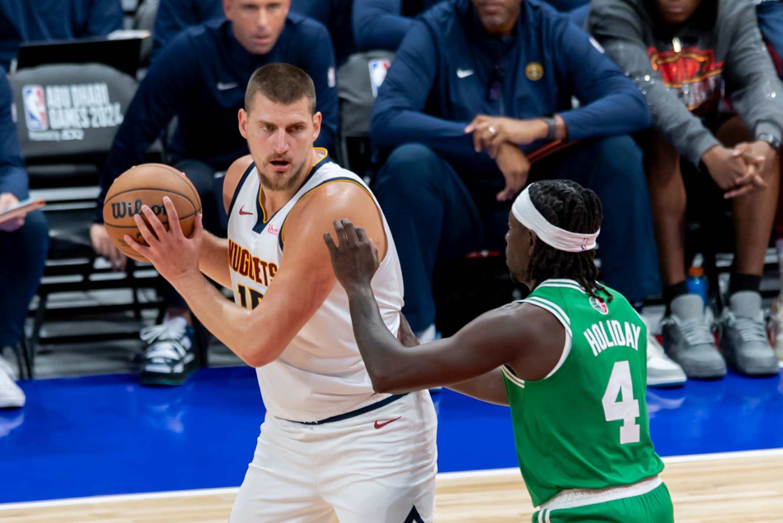 ABU DHABI, UNITED ARAB EMIRATES - OCTOBER 06: Nikola Jokic (L) of Denver Nuggets and Jrue Holiday (R) of Boston Celtics in action during the NBA Preseason match between Denver Nuggets and Boston Celtics at Etihad Arena in Abu Dhabi, United Arab Emirates on October 06, 2024. (Photo by Waleed Zein/Anadolu via Getty Images)