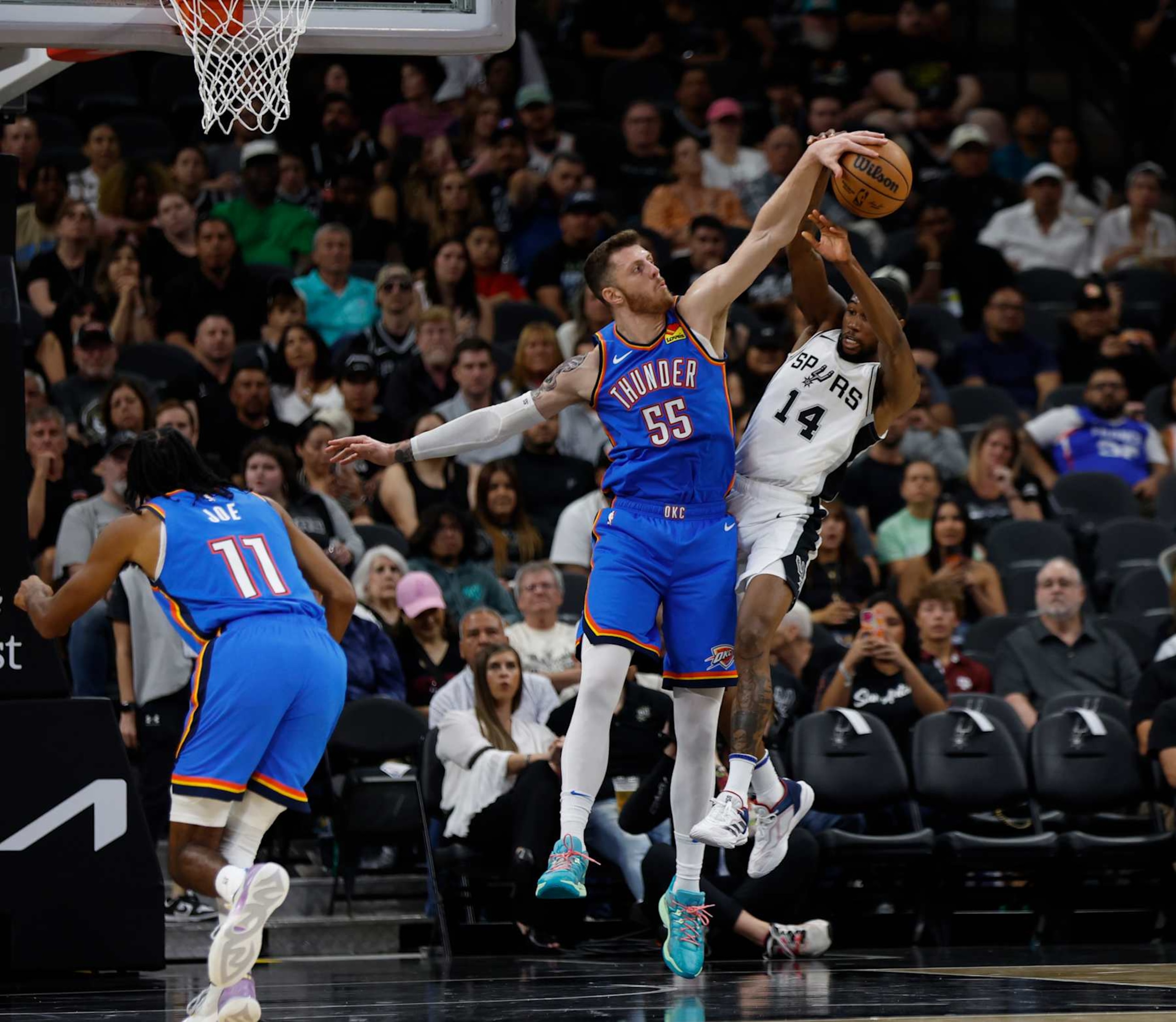 SAN ANTONIO, TX - OCTOBER 07: Isaiah Hartenstein #55 of the Oklahoma City Thunder blocks the shot of Blake Wesley #14 of the San Antonio Spurs in the first half of a preseason game at Frost Bank Center on October 7, 2024 in San Antonio, Texas. NOTE TO USER: User expressly acknowledges and agrees that, by downloading and or using this photograph, User is consenting to terms and conditions of the Getty Images License Agreement. (Photo by Ronald Cortes/Getty Images)