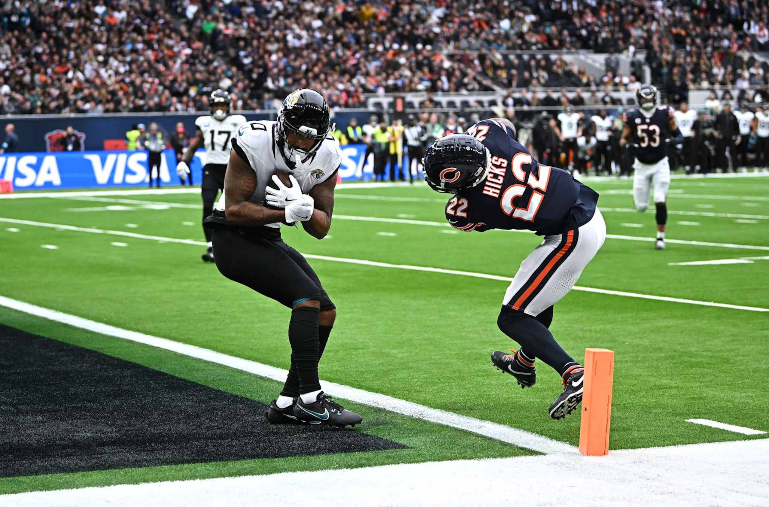 LONDON, ENGLAND - OCTOBER 13: Gabe Davis of Jacksonville Jaguars scores a touchdown under pressure from Elijah Hicks of Chicago Bears  during the NFL match between Jacksonville Jaguars and Chicago Bears at Tottenham Hotspur Stadium on October 13, 2024 in London, England. (Photo by Harry Murphy/Getty Images)