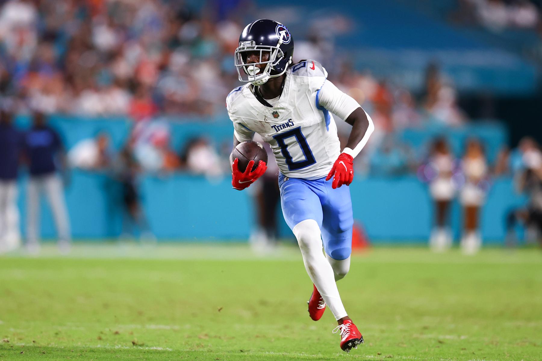 MIAMI GARDENS, FLORIDA - SEPTEMBER 30: Calvin Ridley #0 of the Tennessee Titans carries the ball against the Miami Dolphins during the second half of the game at Hard Rock Stadium on September 30, 2024 in Miami Gardens, Florida. (Photo by Megan Briggs/Getty Images)