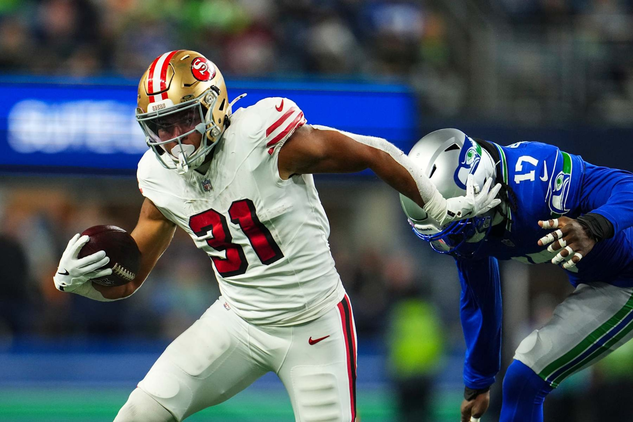 SEATTLE, WA - OCTOBER 10: Isaac Guerendo #31 of the San Francisco 49ers runs the ball during an NFL football game against the Seattle Seahawks at Lumen Field on October 10, 2024 in Seattle, Washington. (Photo by Cooper Neill/Getty Images)