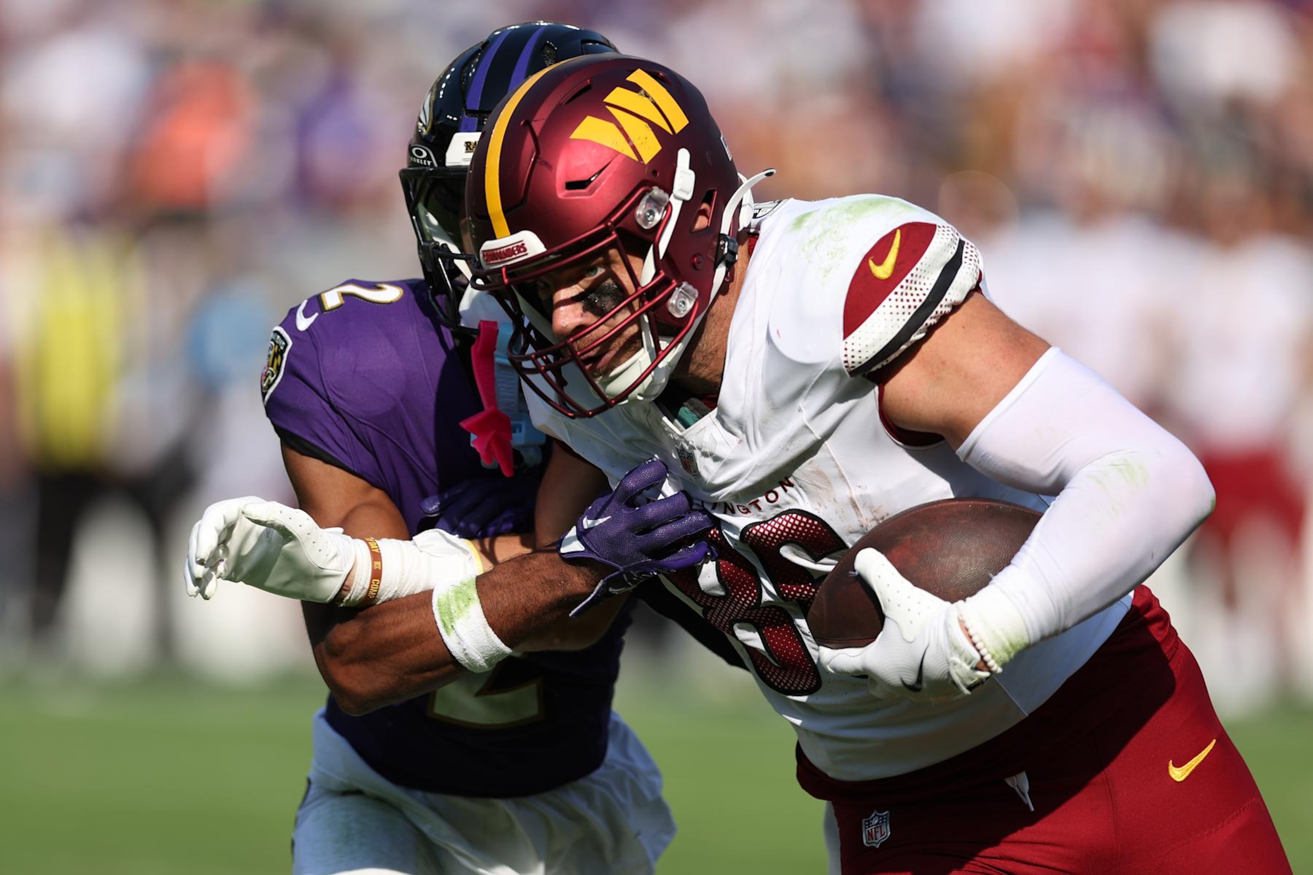 BALTIMORE, MARYLAND - OCTOBER 13: Nate Wiggins #2 of the Baltimore Ravens tackles Zach Ertz #86 of the Washington Commanders during the third quarter at M&T Bank Stadium on October 13, 2024 in Baltimore, Maryland. (Photo by Rob Carr/Getty Images)