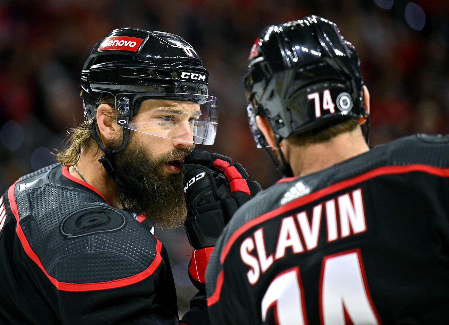 RALEIGH, NORTH CAROLINA - FEBRUARY 19: Brent Burns #8 and Jaccob Slavin #74 of the Carolina Hurricanes talk during the first period against the Chicago Blackhawks at PNC Arena on February 19, 2024 in Raleigh, North Carolina. (Photo by Grant Halverson/Getty Images)