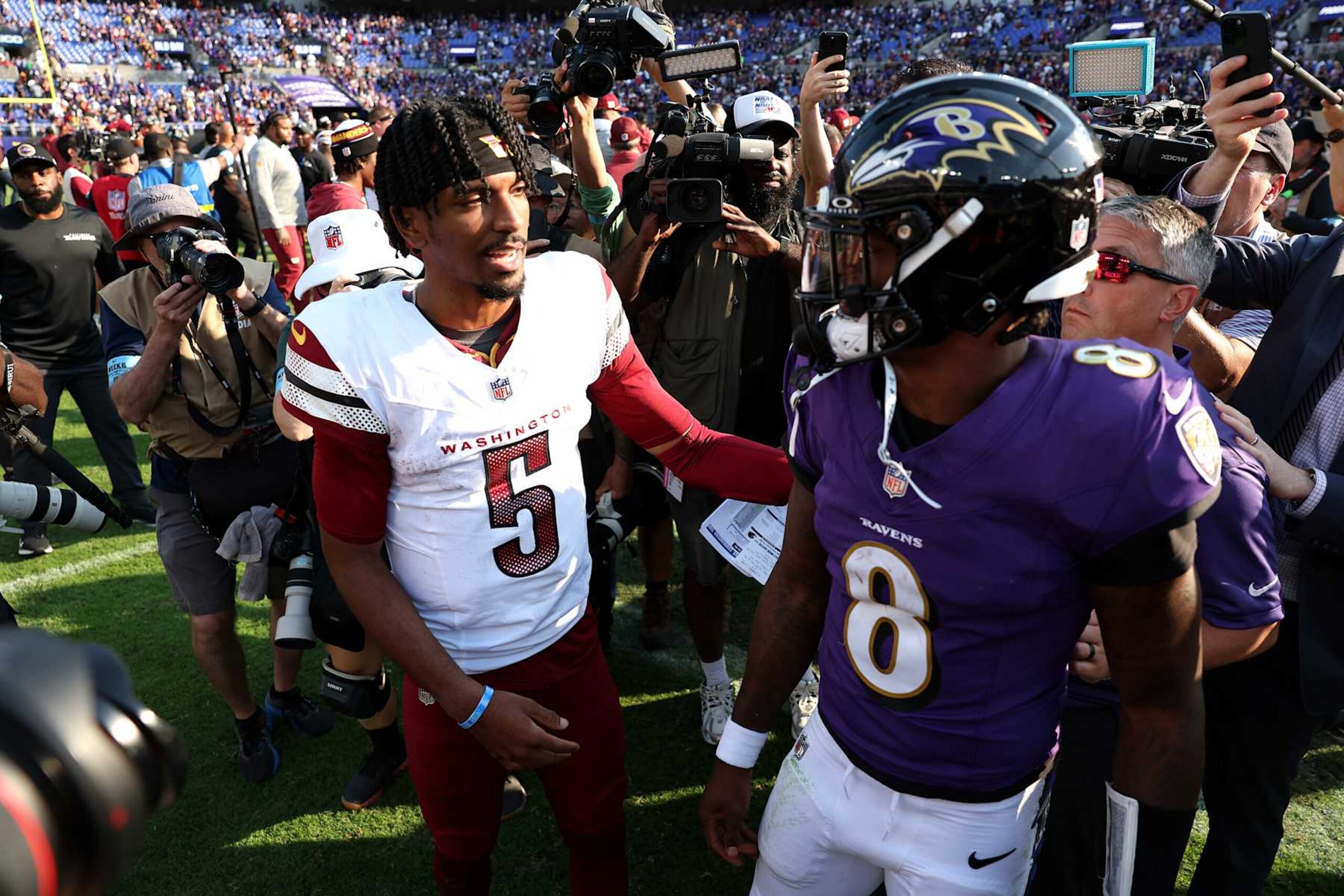 BALTIMORE, MARYLAND - OCTOBER 13: Lamar Jackson #8 of the Baltimore Ravens and Jayden Daniels #5 of the Washington Commanders greet one another after the Ravens 30-23 win at M&T Bank Stadium on October 13, 2024 in Baltimore, Maryland. (Photo by Patrick Smith/Getty Images)