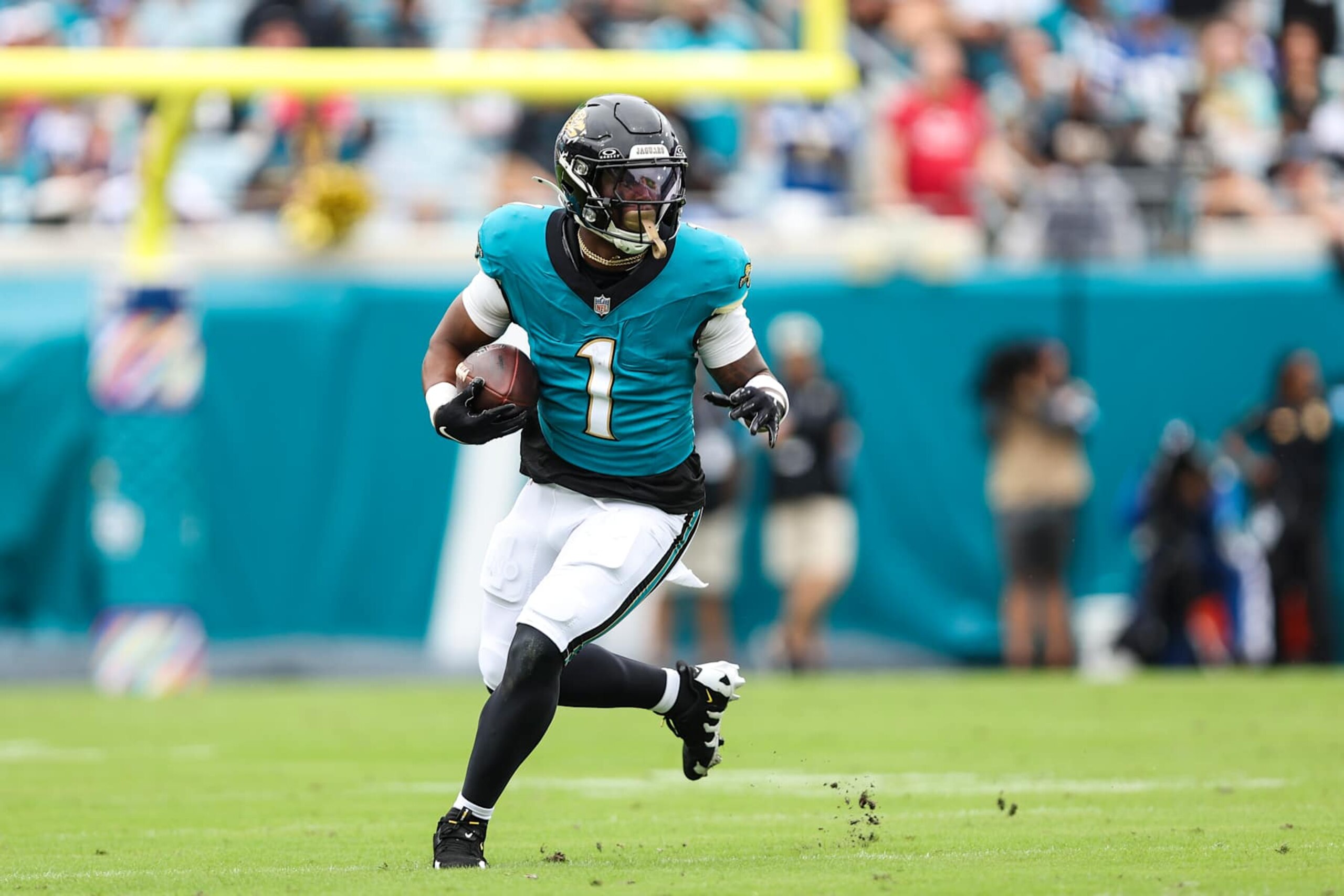 JACKSONVILLE, FLORIDA - OCTOBER 06: Travis Etienne Jr. #1 of the Jacksonville Jaguars runs with the ball during an NFL football game against the Indianapolis Colts at EverBank Stadium on October 6, 2024 in Jacksonville, Florida. (Photo by Perry Knotts/Getty Images)