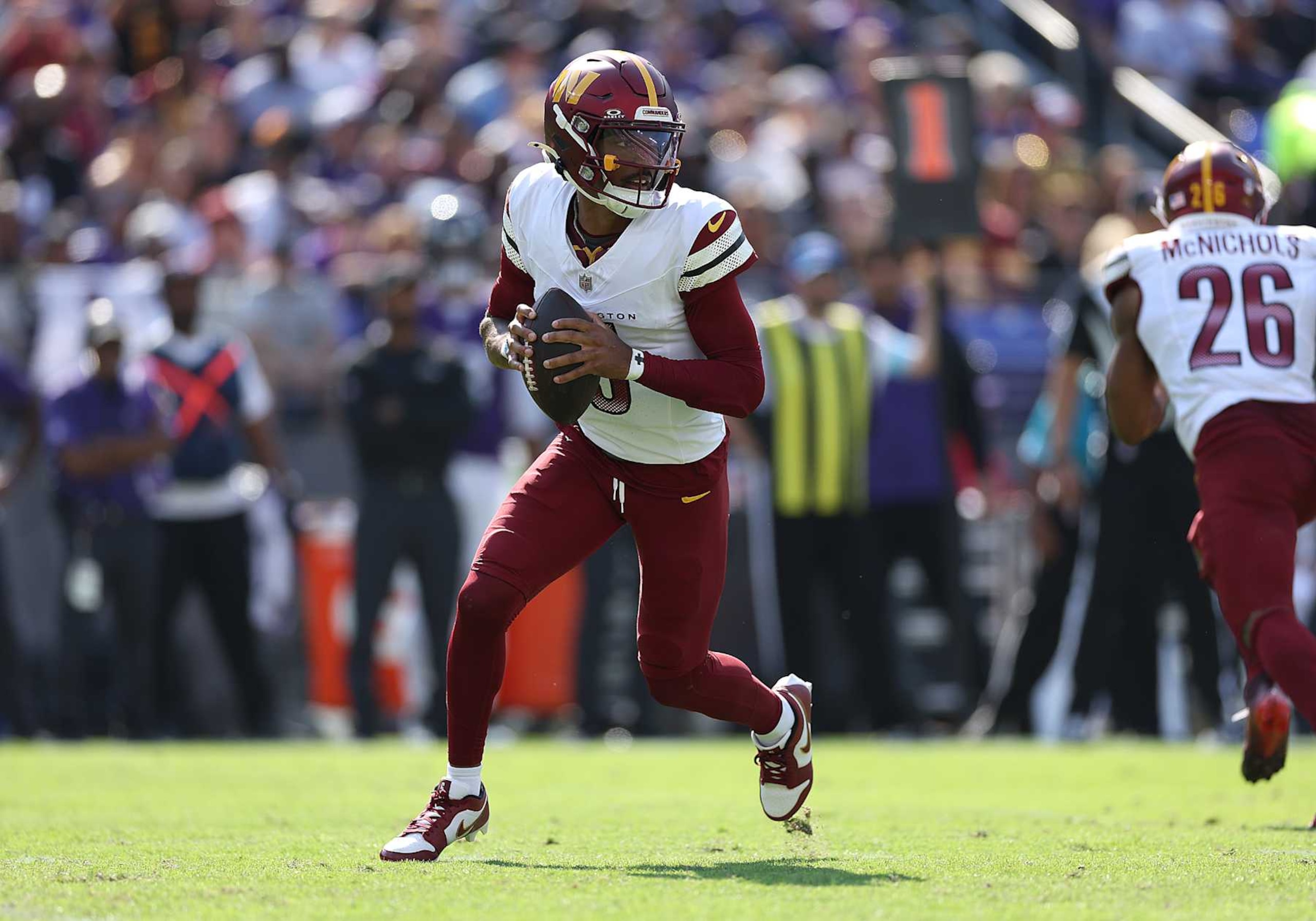 BALTIMORE, MARYLAND - OCTOBER 13: Jayden Daniels #5 of the Washington Commanders looks to pass against the Baltimore Ravens during the second quarter at M&T Bank Stadium on October 13, 2024 in Baltimore, Maryland. (Photo by Patrick Smith/Getty Images)