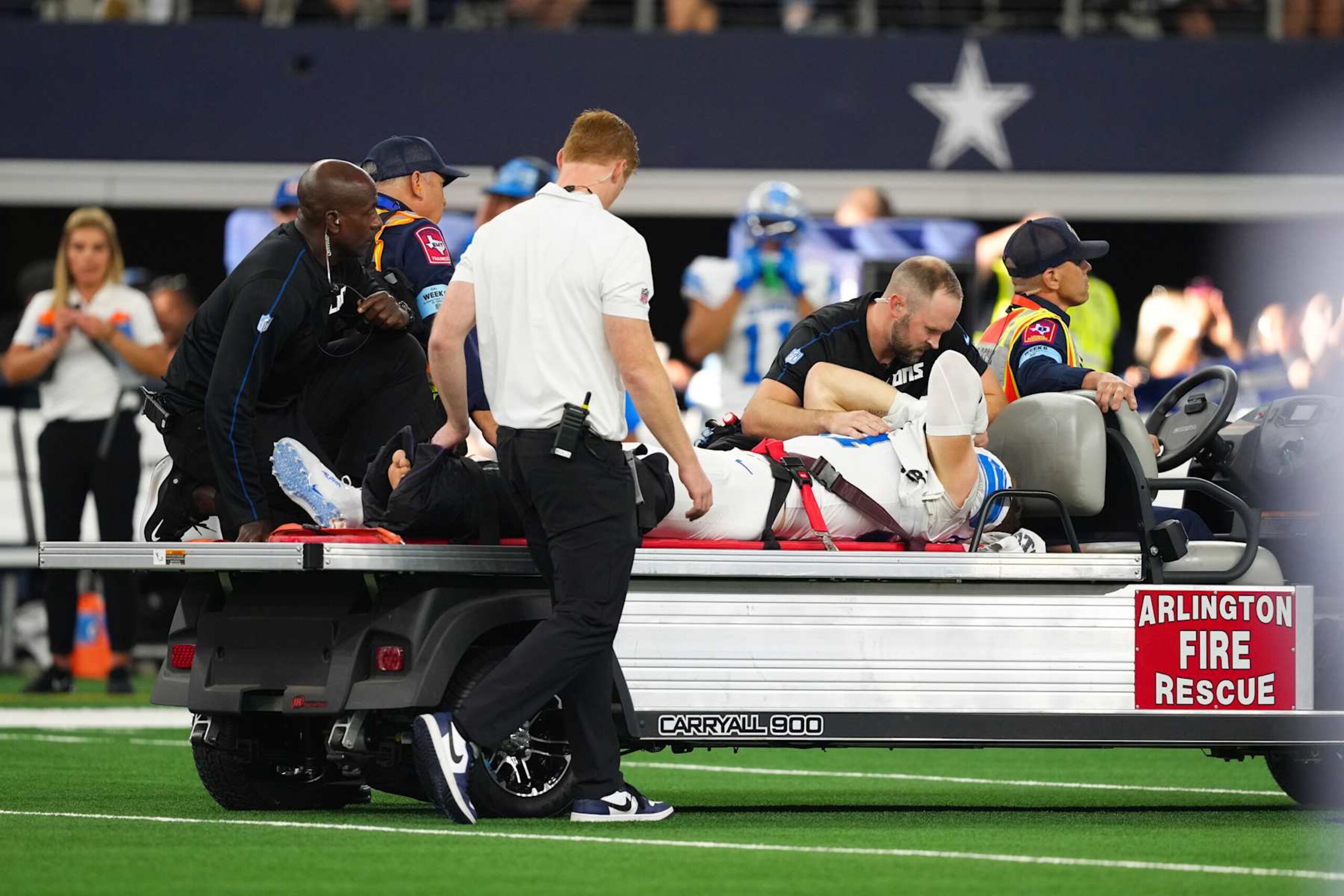 ARLINGTON, TEXAS - OCTOBER 13: Aidan Hutchinson #97 of the Detroit Lions is taken off the field on a medical cart after injuring his leg on a play in the third quarter of a game against the Dallas Cowboys at AT&T Stadium on October 13, 2024 in Arlington, Texas. (Photo by Sam Hodde/Getty Images) ARLINGTON, TEXAS - OCTOBER 13: Aidan Hutchinson #97 of the Detroit Lions is taken off the field on a medical cart after injuring his leg on a play in the third quarter of a game against the Dallas Cowboys at AT&T Stadium on October 13, 2024 in Arlington, Texas. (Photo by Sam Hodde/Getty Images)