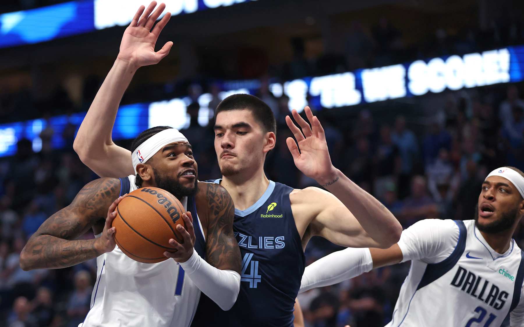 DALLAS, TX - OCTOBER 7: Jaden Hardy #1 of the Dallas Mavericks drives to the basket against Zach Edey #14 of the Memphis Grizzlies in the first half of a preseason game at American Airlines Center on October 7, 2024 in Dallas, Texas. NOTE TO USER: User expressly acknowledges and agrees that, by downloading and or using this photograph, User is consenting to the terms and conditions of the Getty Images License Agreement. (Photo by Ron Jenkins/Getty Images)
