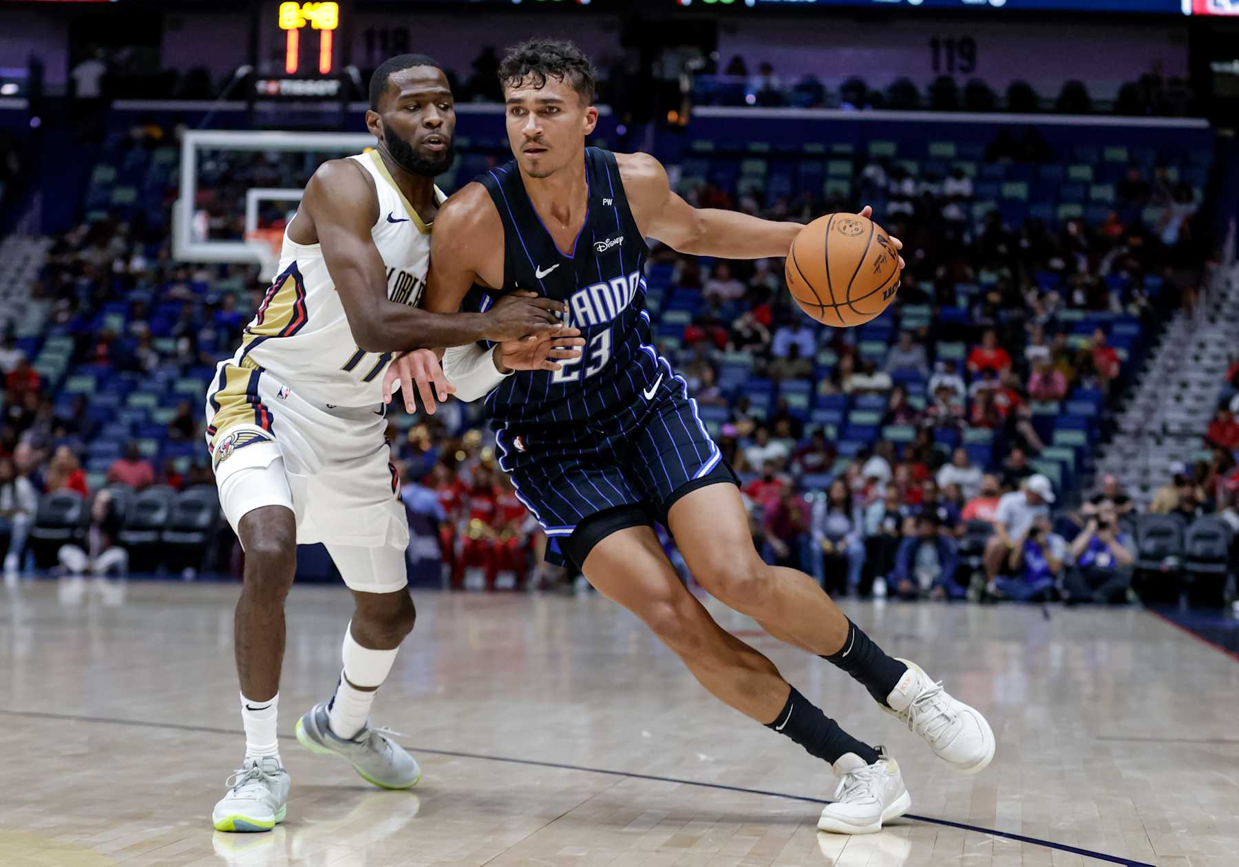 NEW ORLEANS, LOUISIANA - OCTOBER 7:  Tristan da Silva #23 of the Orlando Magic drives in against Jalen Crutcher #11 of the New Orleans Pelicans during the second half of a preseason game at the Smoothie King Center on October 7, 2024 in New Orleans, Louisiana. NOTE TO USER: User expressly acknowledges and agrees that, by downloading and or using this photograph, User is consenting to the terms and conditions of the Getty Images License Agreement. (Photo by Derick E. Hingle/Getty Images)
