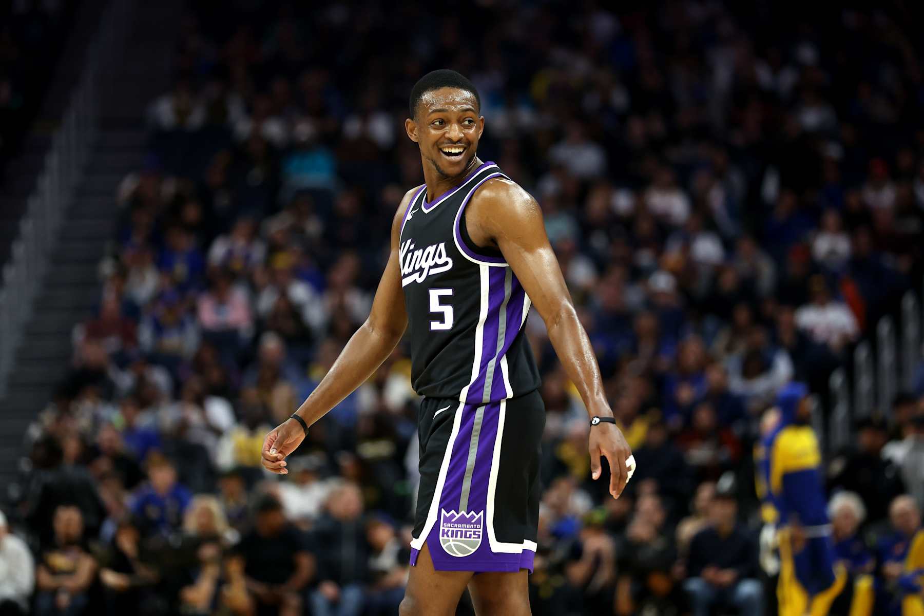 SAN FRANCISCO, CALIFORNIA - OCTOBER 11: De'Aaron Fox #5 of the Sacramento Kings smiles during the first half of their preseason game against the Golden State Warriors at Chase Center on October 11, 2024 in San Francisco, California.  NOTE TO USER: User expressly acknowledges and agrees that, by downloading and/or using this photograph, user is consenting to the terms and conditions of the Getty Images License Agreement.  (Photo by Ezra Shaw/Getty Images)