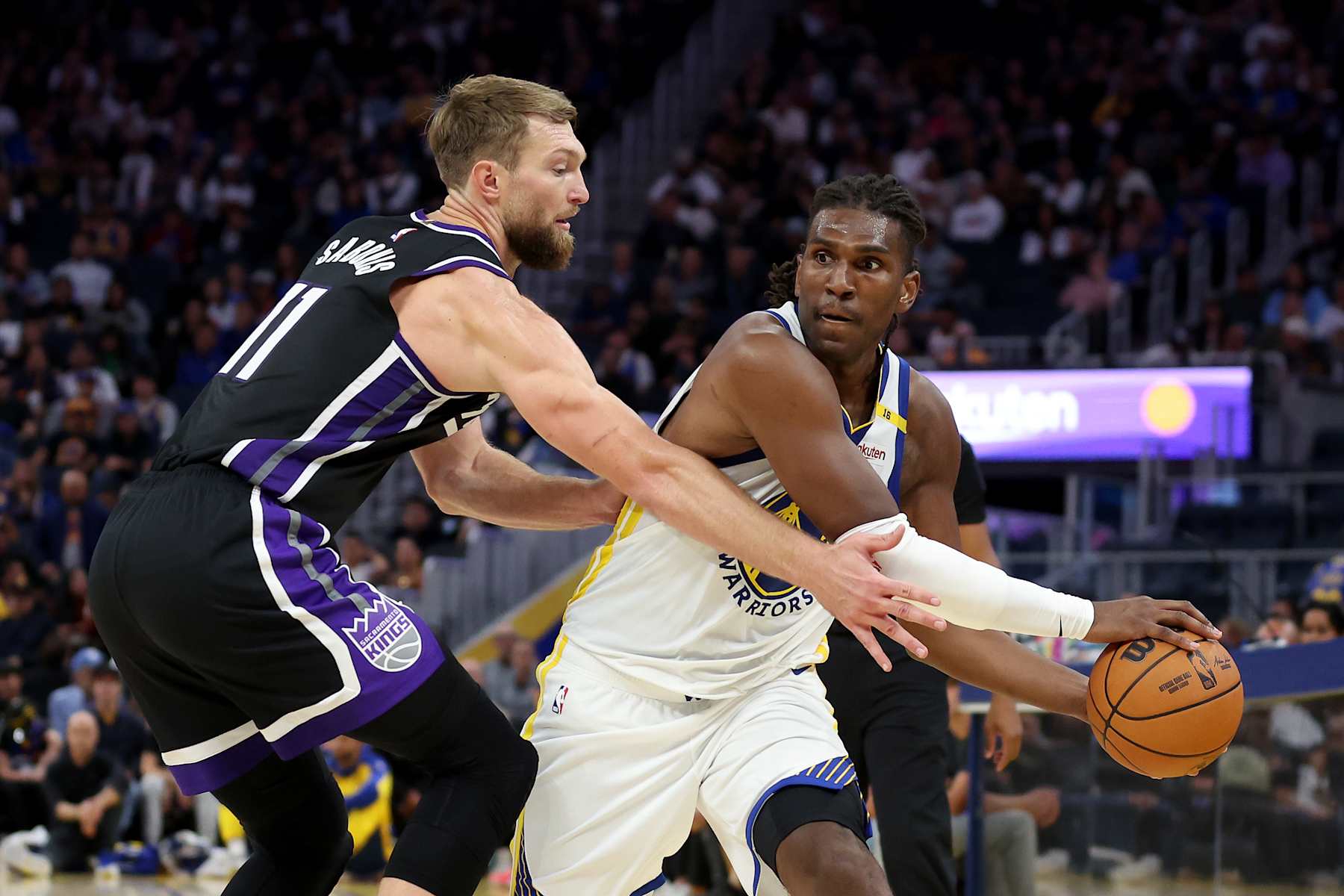 SAN FRANCISCO, CALIFORNIA - OCTOBER 11: Kevon Looney #5 of the Golden State Warriors is guarded by Domantas Sabonis #11 of the Sacramento Kings during the second half of their preseason game at Chase Center on October 11, 2024 in San Francisco, California.  NOTE TO USER: User expressly acknowledges and agrees that, by downloading and/or using this photograph, user is consenting to the terms and conditions of the Getty Images License Agreement.  (Photo by Ezra Shaw/Getty Images)
