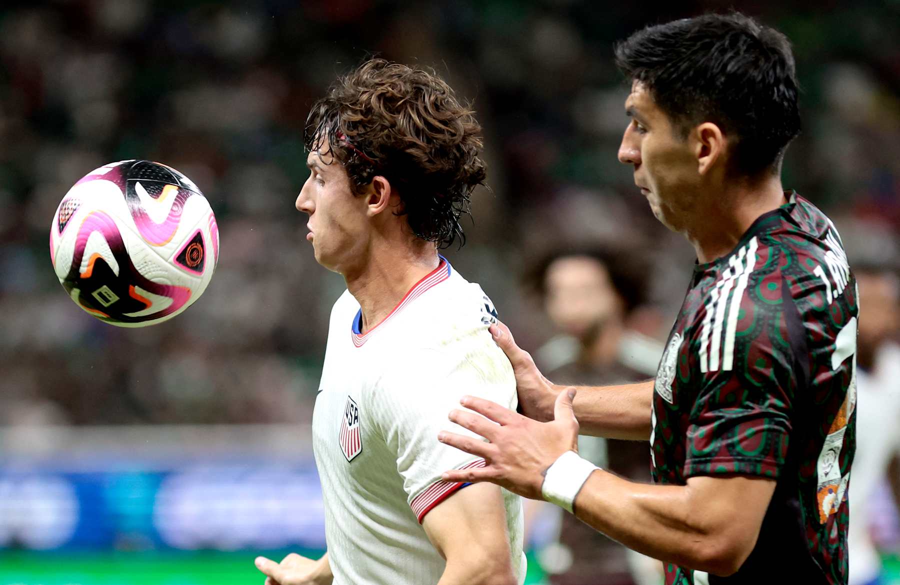 USA's midfielder #11 Brenden Aaronson (L) and Mexico's defender #27 Jesus Angulo fight for the ball during the international friendly football match between Mexico and USA at the Akron Stadium in Zapopan, Jalisco state, Mexico, on October 15, 2024. (Photo by Ulises Ruiz / AFP) (Photo by ULISES RUIZ/AFP via Getty Images)