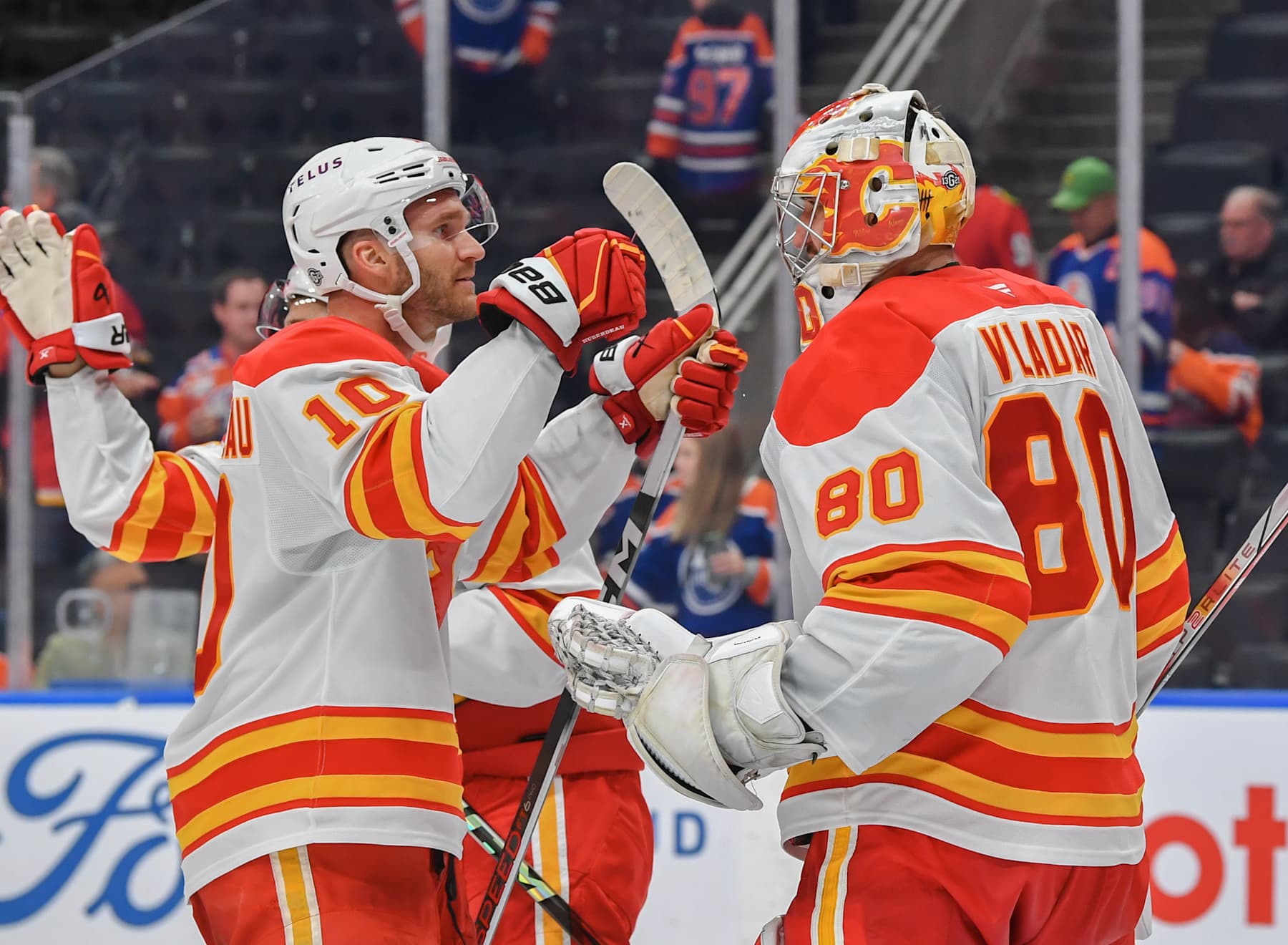 EDMONTON, CANADA - OCTOBER 13: Jonathan Huberdeau #10 and Dan Vladar #80 of the Calgary Flames celebrate a victory over the Edmonton Oilers after the game at Rogers Place on October 13, 2024, in Edmonton, Alberta, Canada. (Photo by Andy Devlin/NHLI via Getty Images)